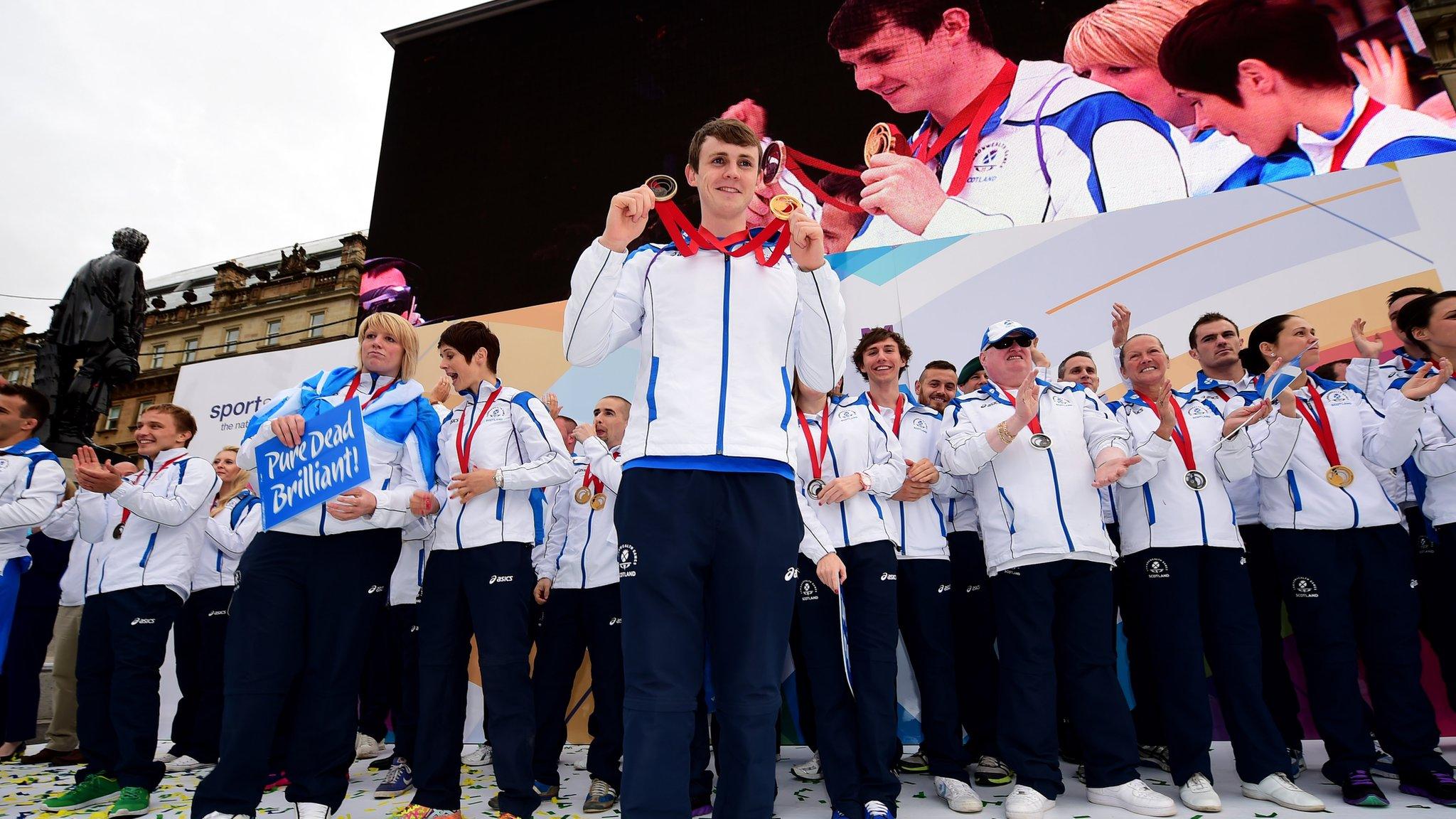 Team Scotland swimmer Ross Murdoch shows off his medals following Glasgow 2014