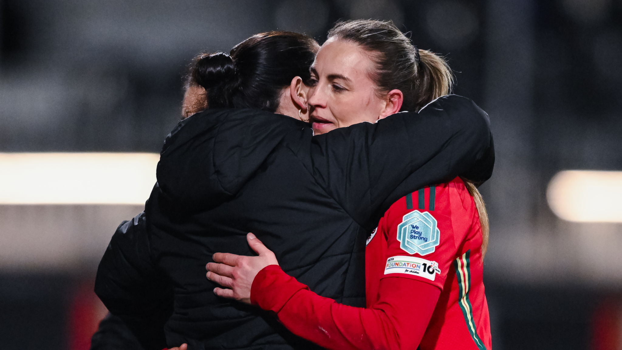 Wales women's manager Rhian Wilkinson embraces Kayleigh Barton during the Nations League games against Sweden.