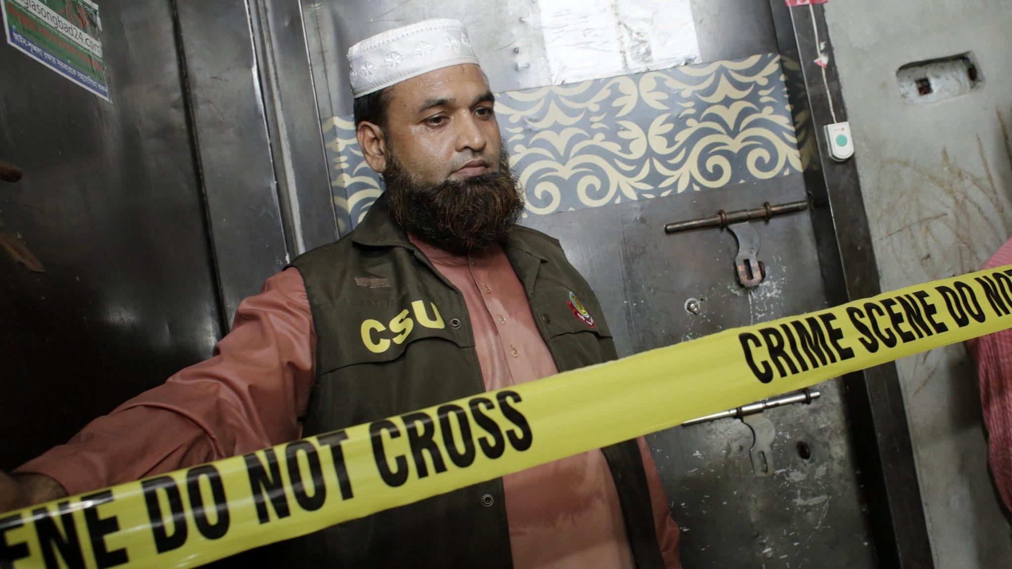 File photo: Members of the Crime Scene Unit stands guard in front of the gate of blogger Niloy Chakrabarty Neel's flat, after he was hacked to death by unknown assailants in Dhaka, Bangladesh 07 August 2015