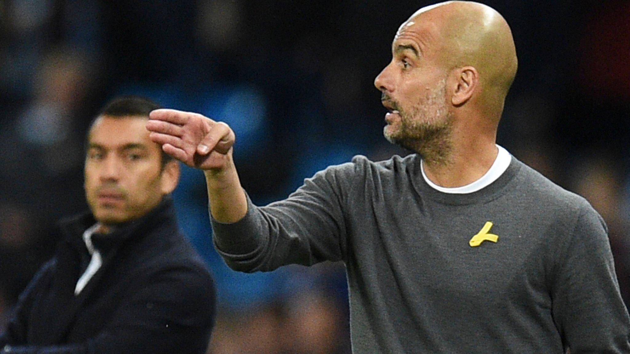 Pep Guardiola wearing a yellow ribbon