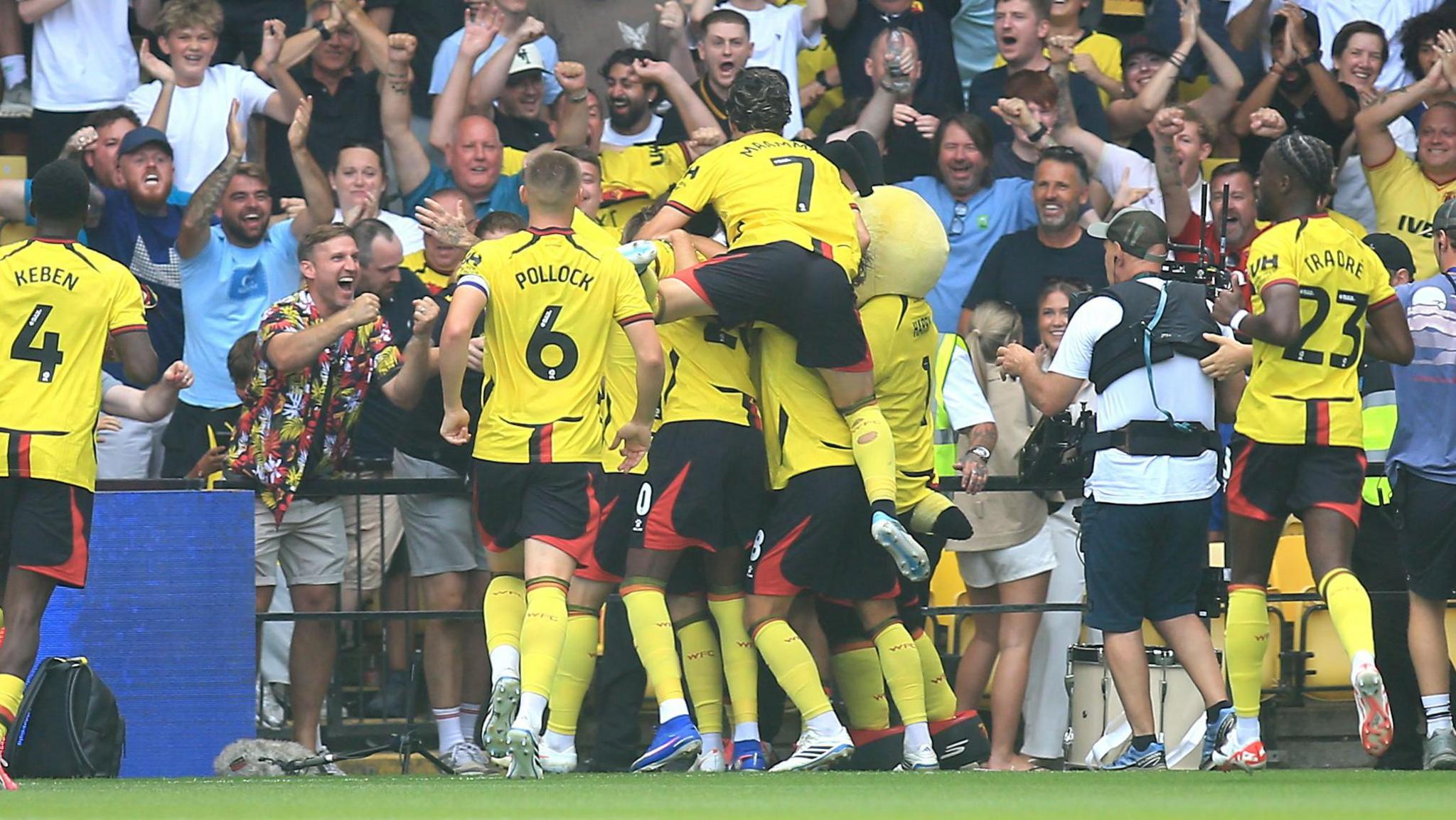 Watford players and fans celebrate after scoring their first goal against Southampton.