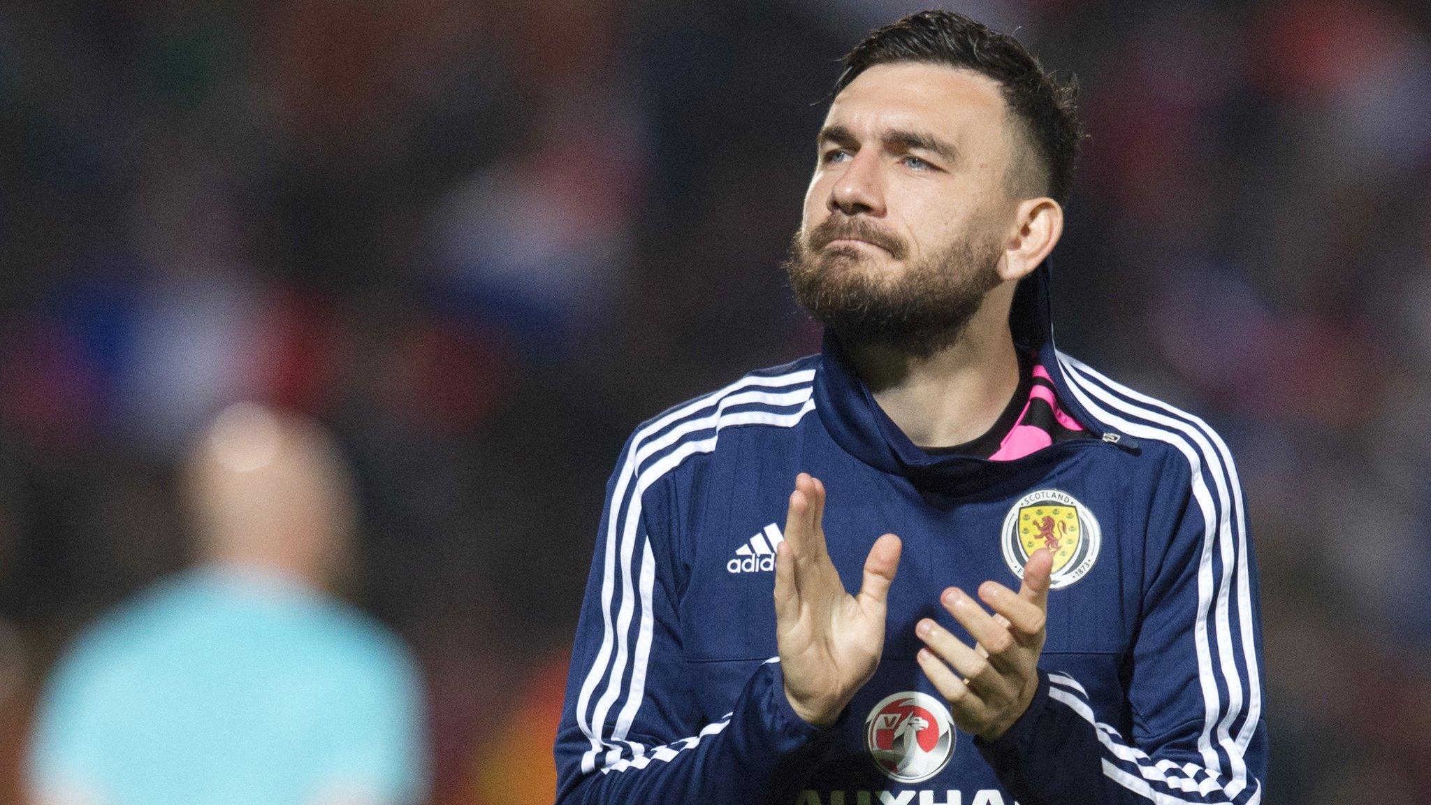 Robert Snodgrass applauds Scotland fans after their friendly defeat by France in Paris