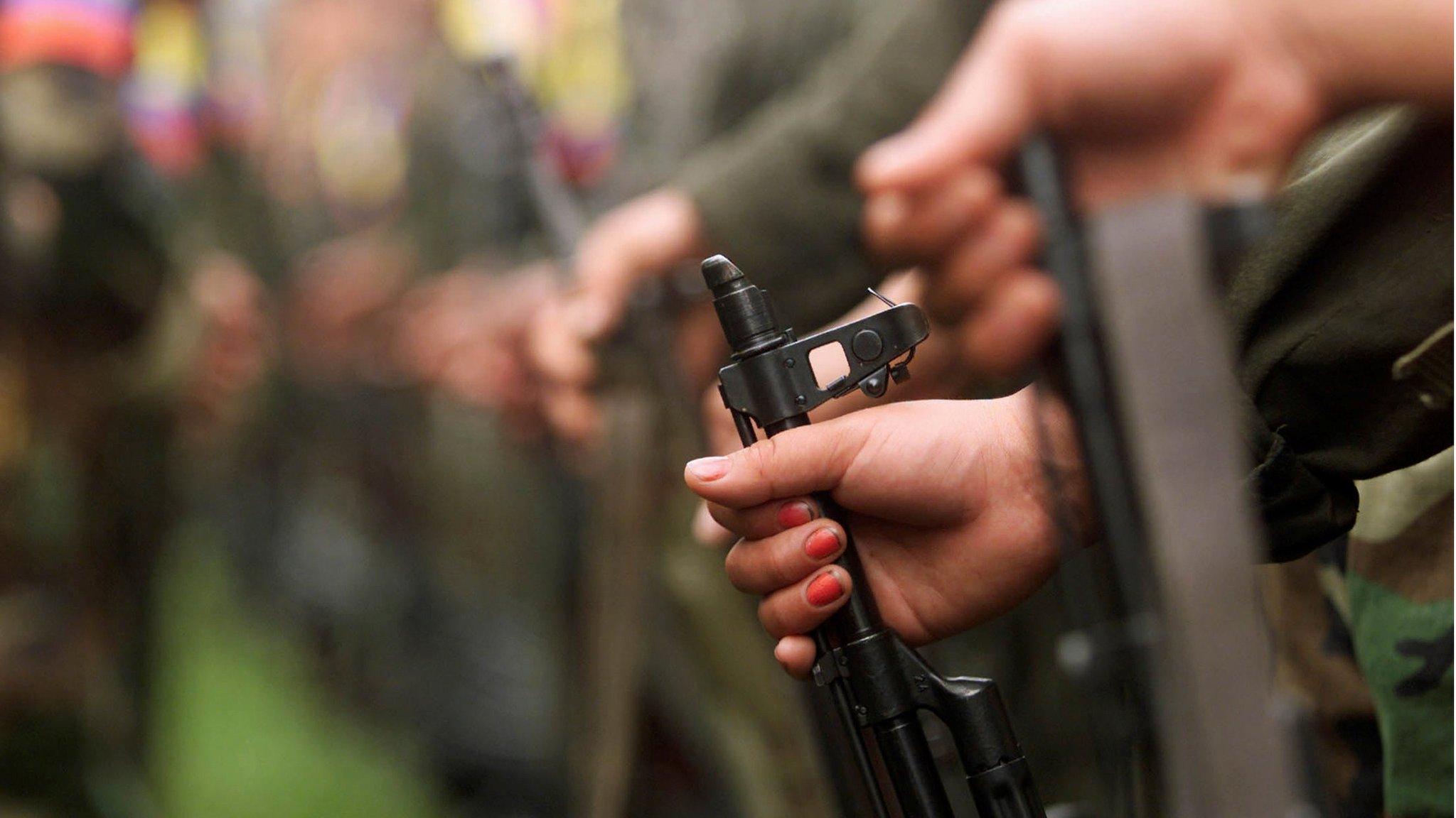 A Colombian guerrilla woman holds her AK-47 as she takes part in a line of rebels during an army parade of fighters of the Farc in Villa Colombia camp near San Vicente del Caguan, Caqueta province, Colombia, 29 April 2000.