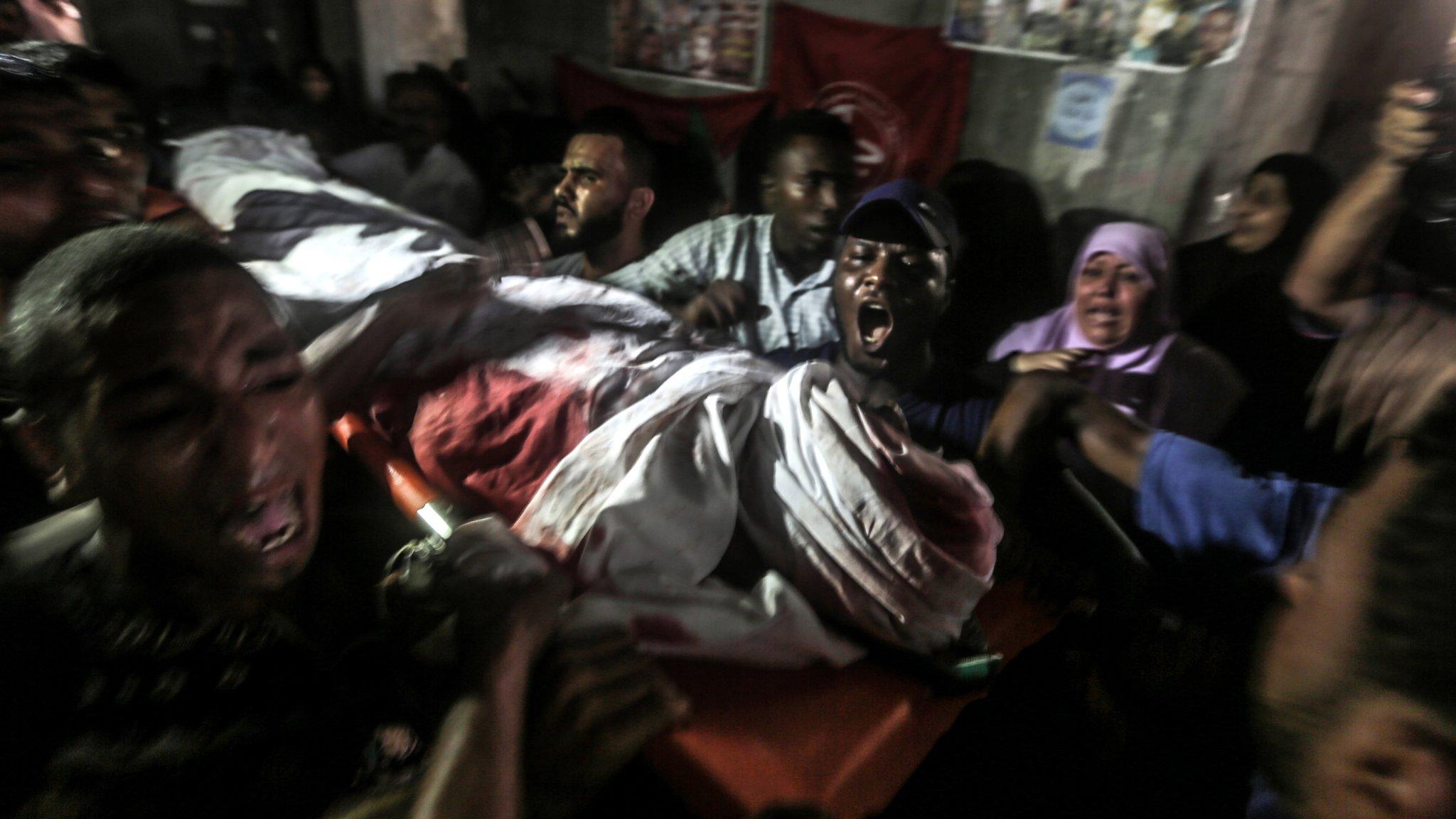 Relatives mourn one of the two Hamas militants killed by Israeli tank fire in northern Gaza on 7 August 2018