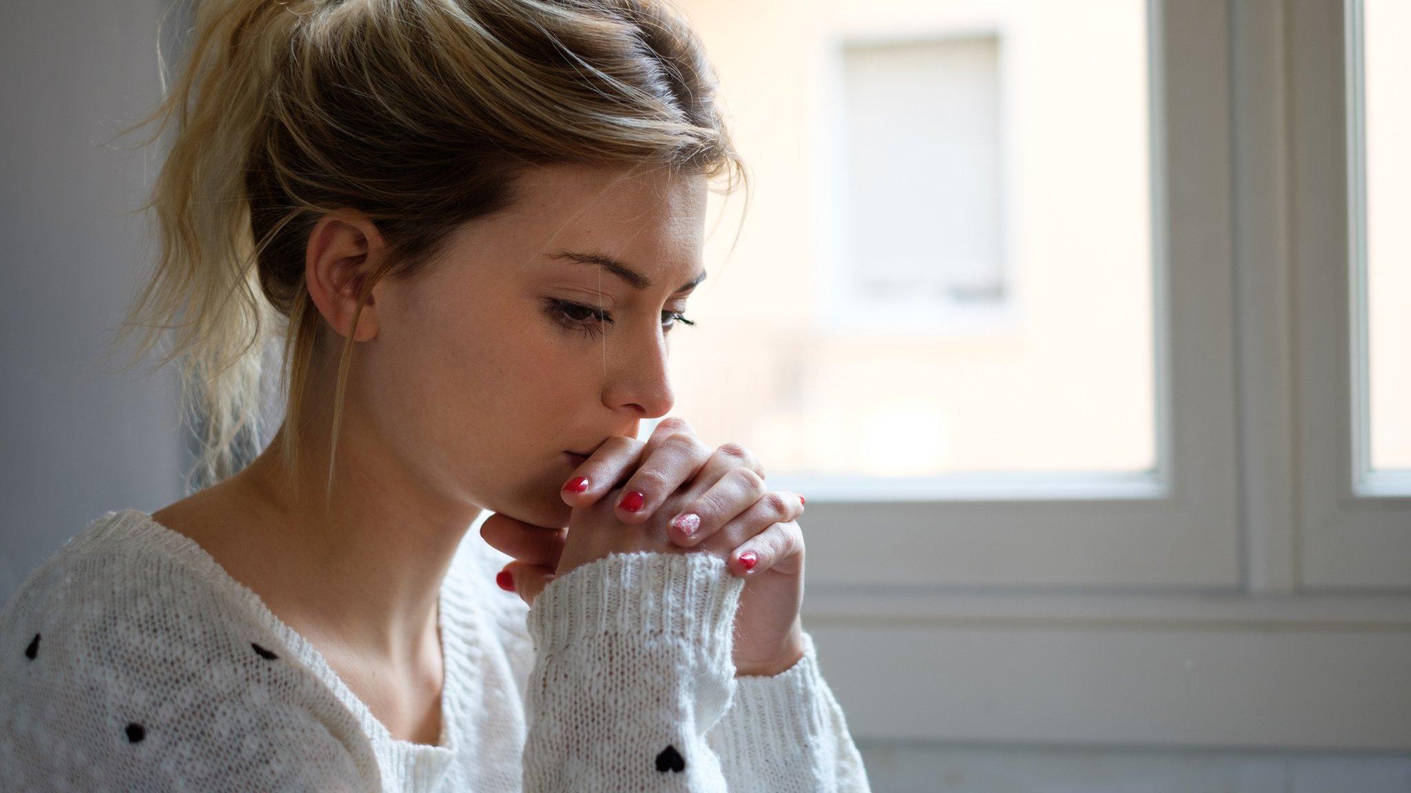 Woman thinking by a window