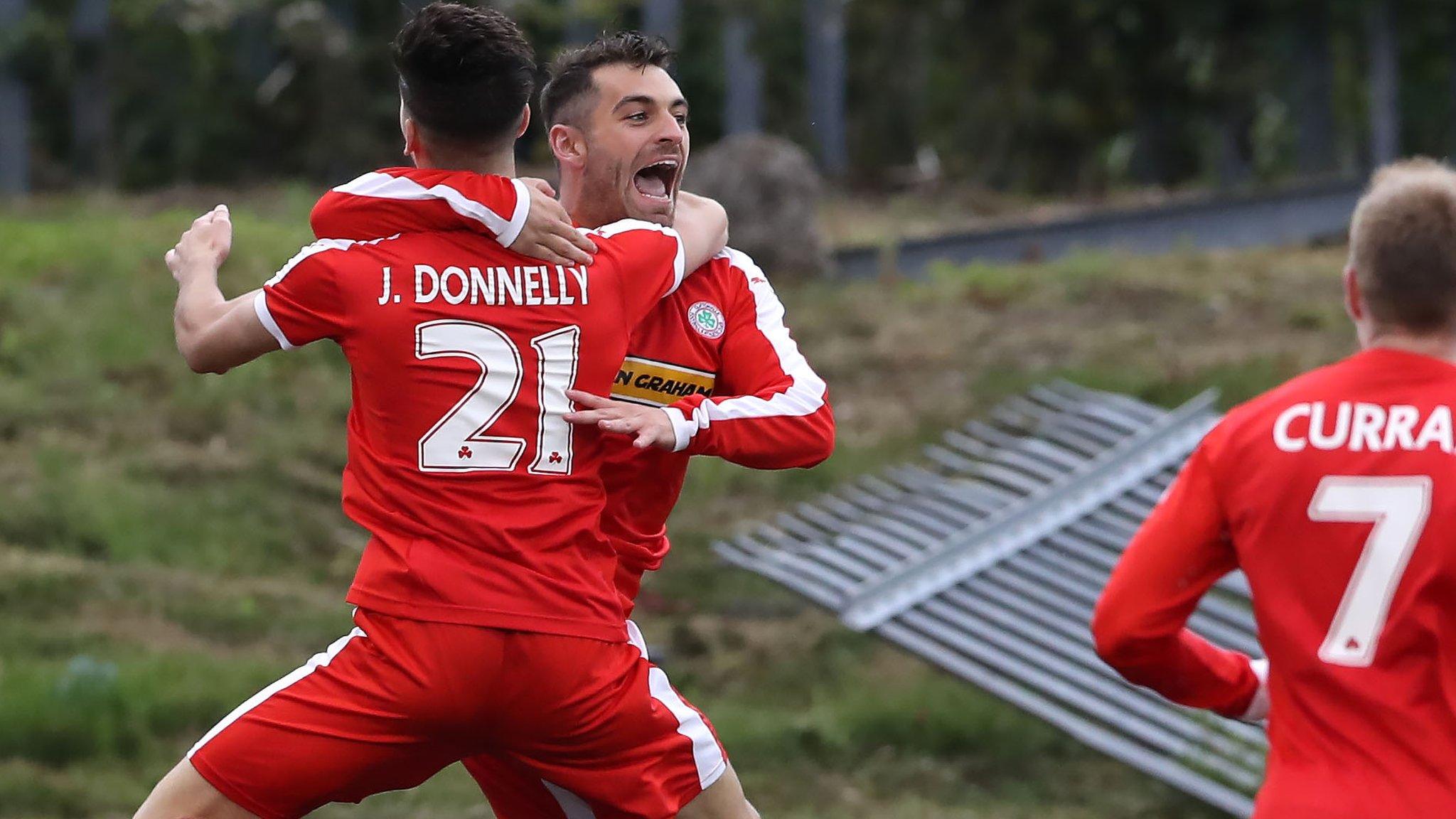 Jay Donnelly celebrates with delighted goalscorer David McDaid