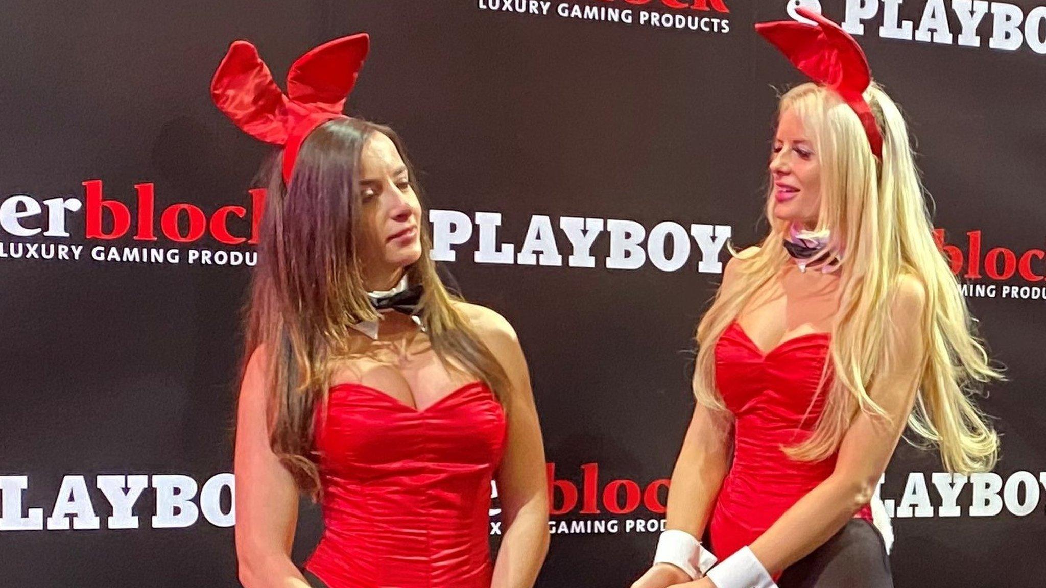 Two women in Playboy bunny outfits