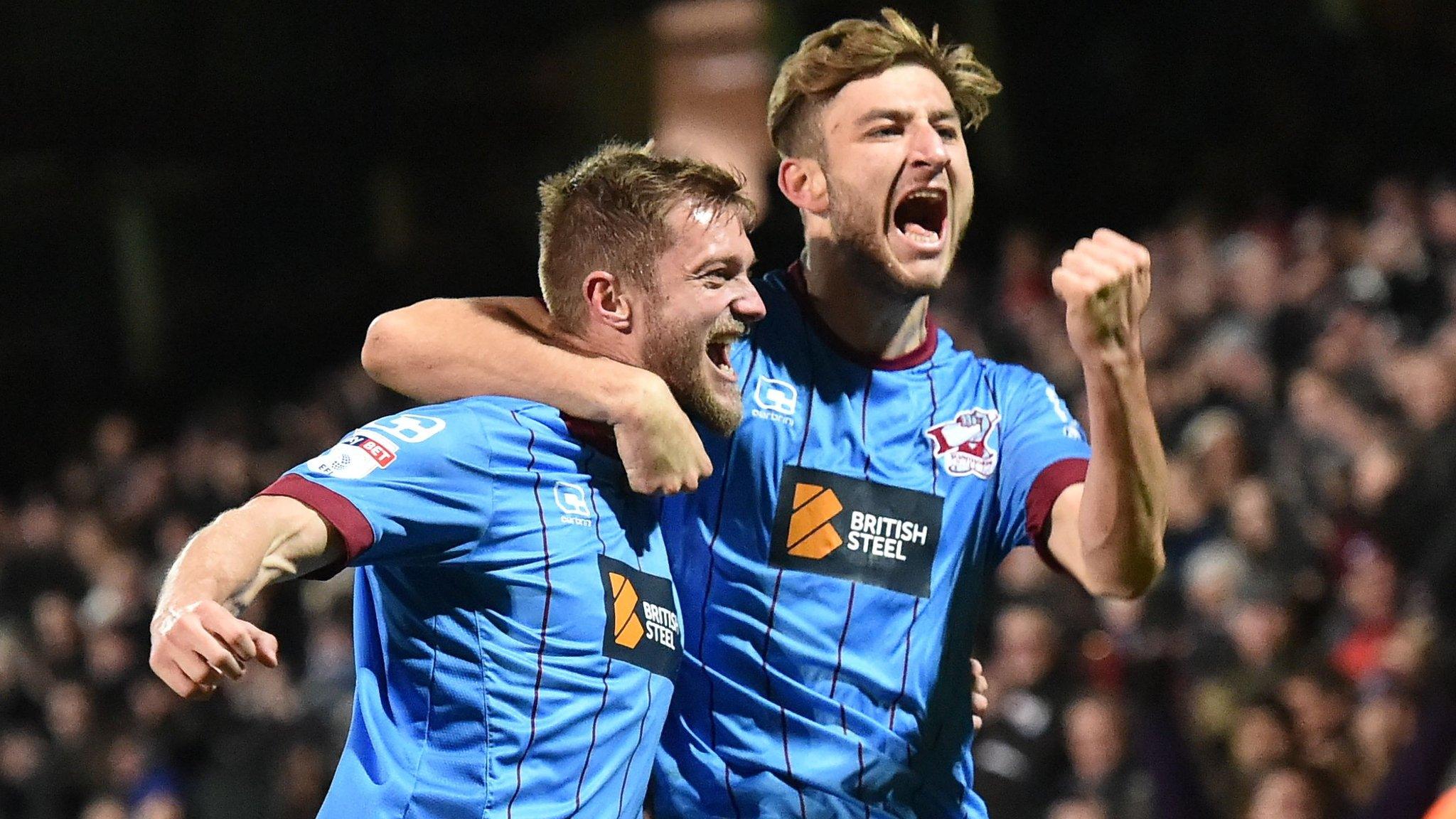 Scott Wiseman (right) celebrates his winner for Scunthorpe