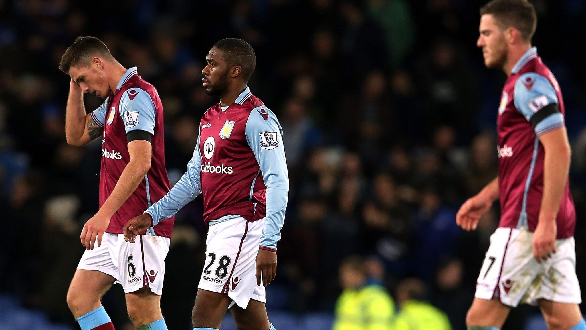 Aston Villa players walk off after defeat to Everton