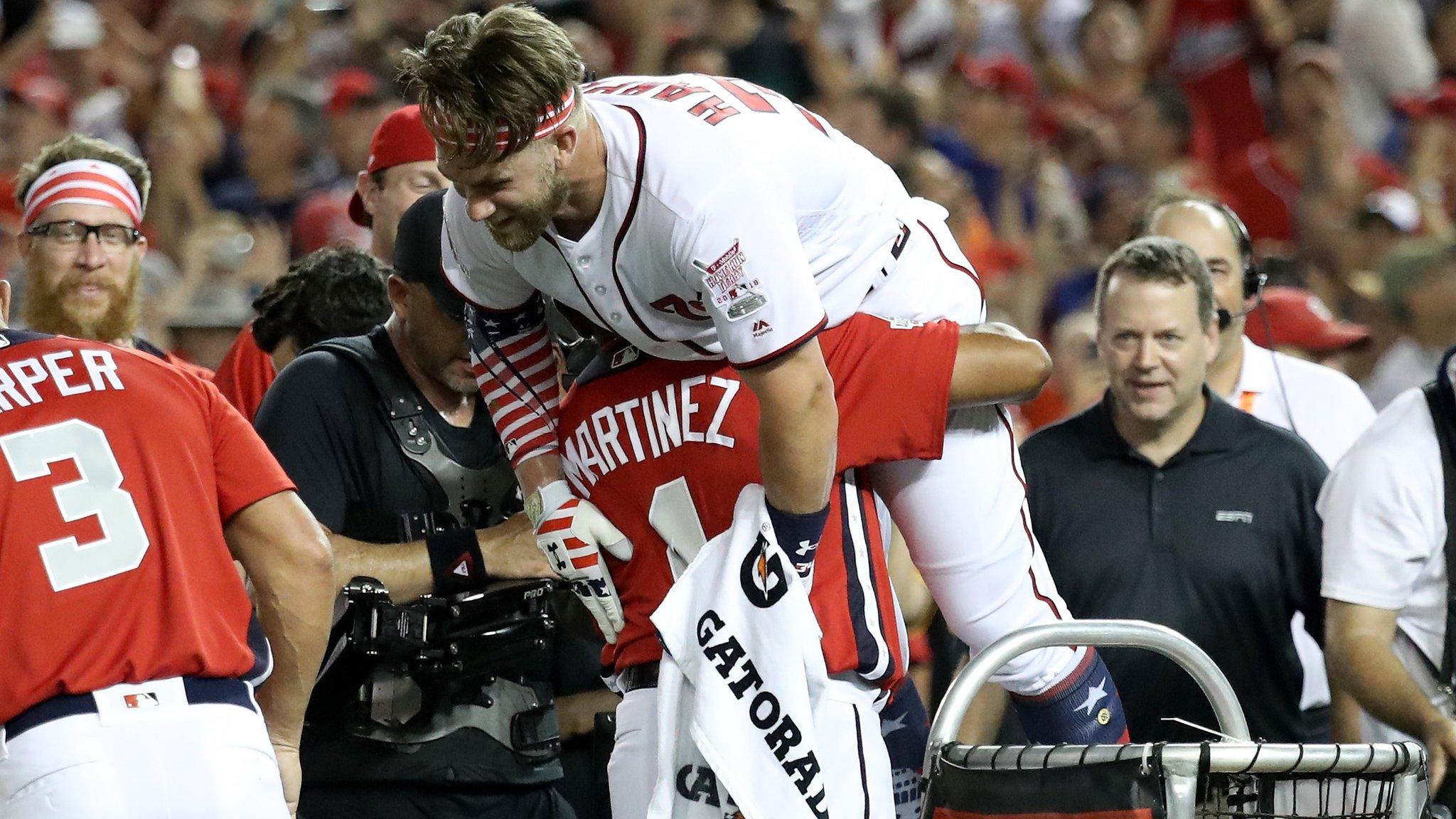 Baseball - WASHINGTON, DC - JULY 16: Bryce Harper of the Washington Nationals and National League celebrates with his manager Dave Martinez after winning the T-Mobile Home Run Derby at Nationals Park on July 16, 2018 in Washington, DC. (Photo by Rob Carr/Getty Images)