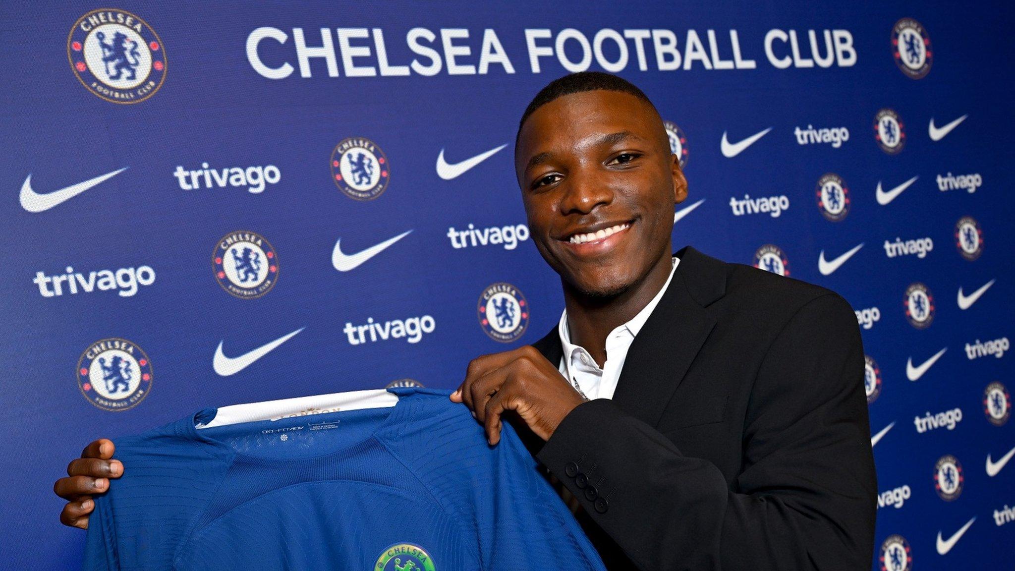 Moises Caicedo holds a Chelsea shirt after signing for the club