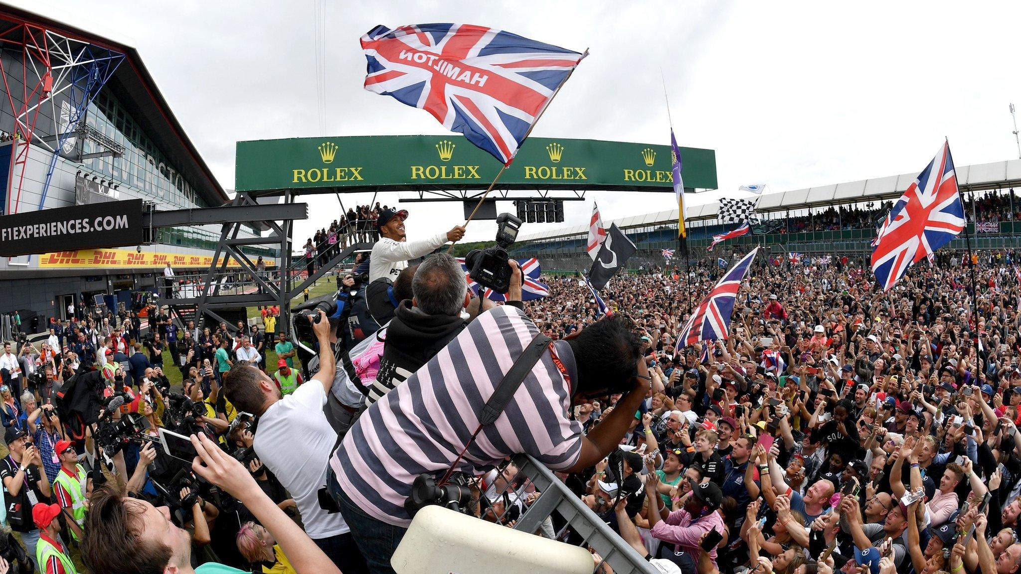 Lewis Hamilton celebrates with fans after his 2017 British GP win at Silverstone