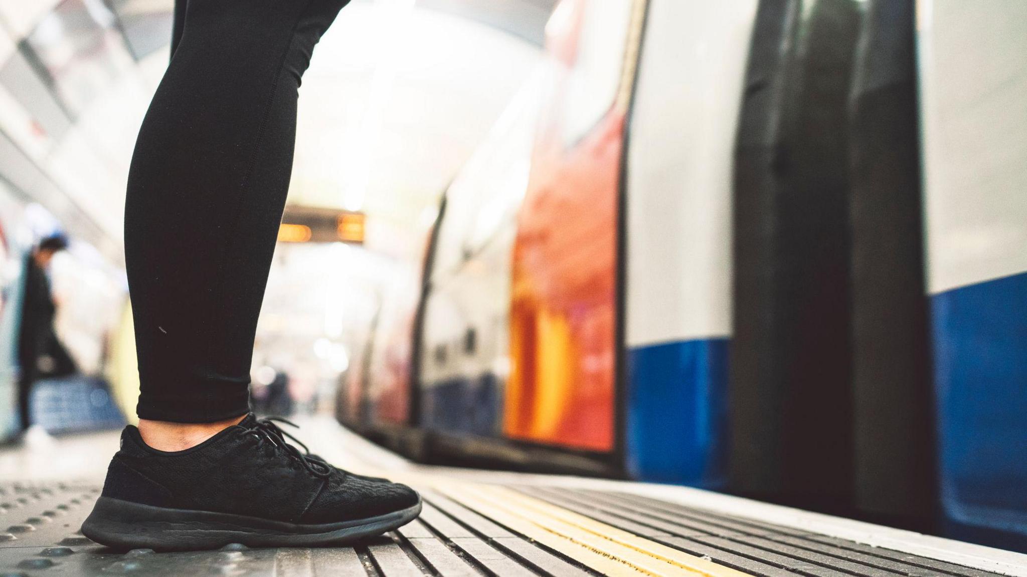 Woman waits for train