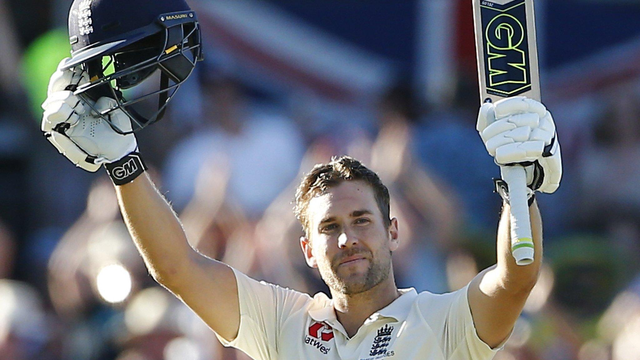 Dawid Malan raises his bat after reaching his century