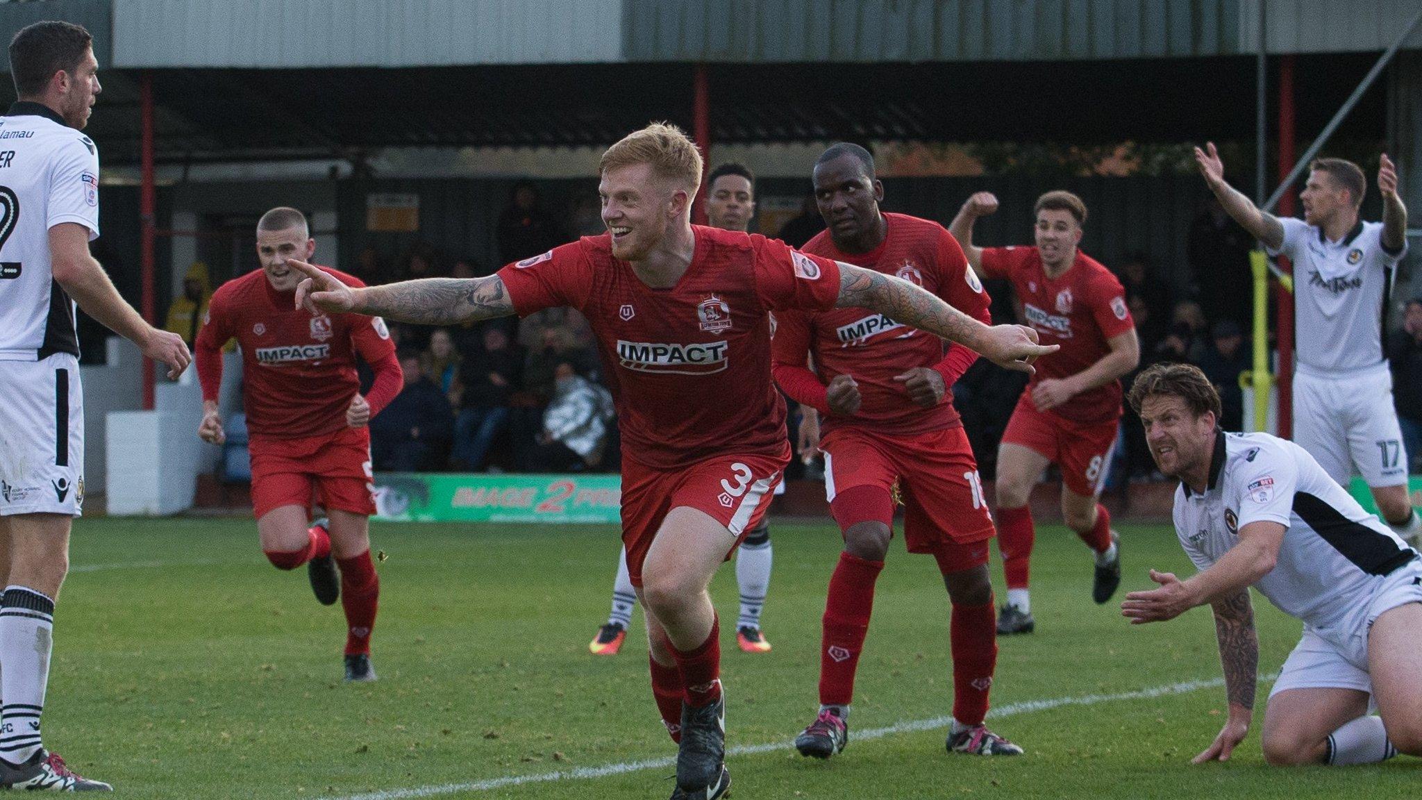 James Kennedy celebrates after scoring against Newport County