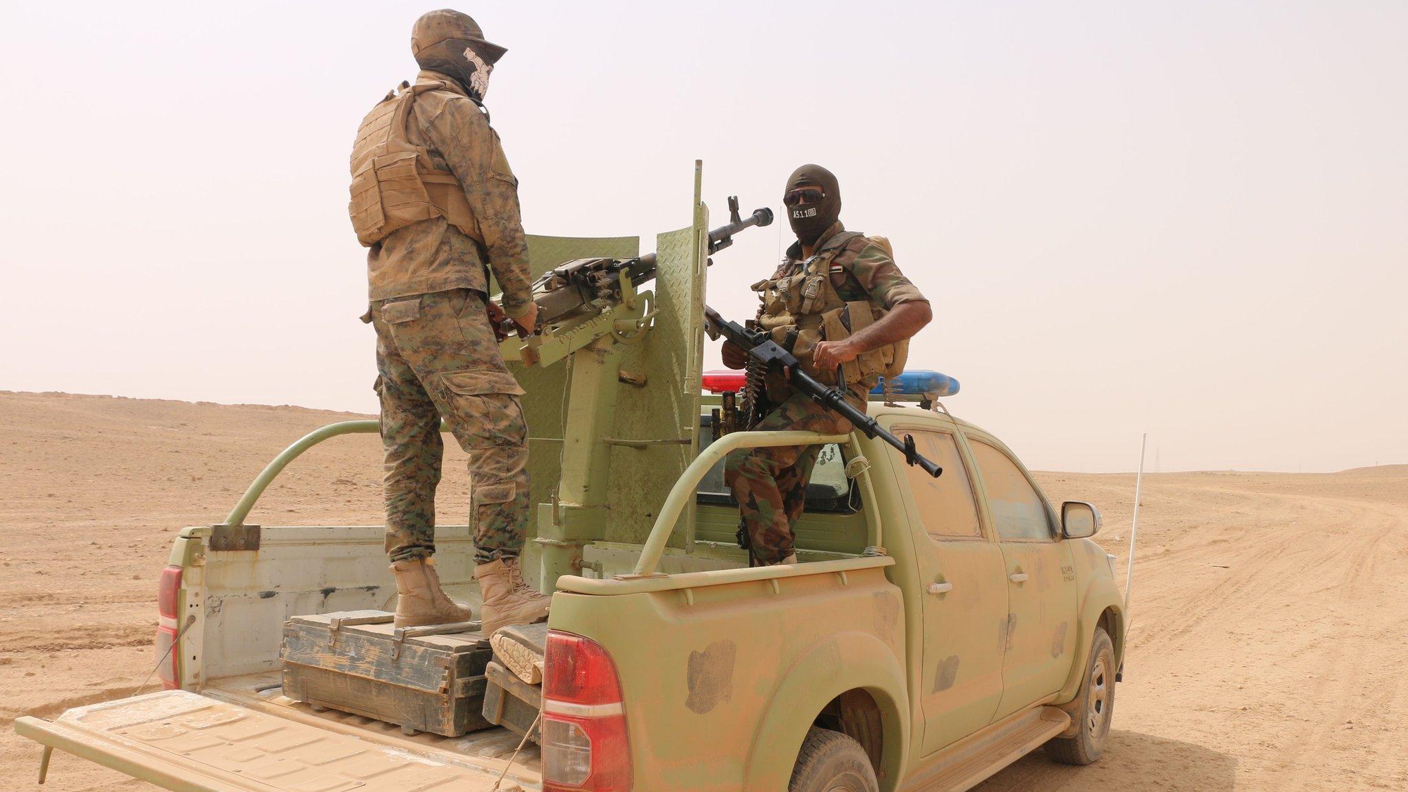 Paramilitary fighters stand on a vehicle south of Ana, in Anbar province, Iraq (20 September 2017)