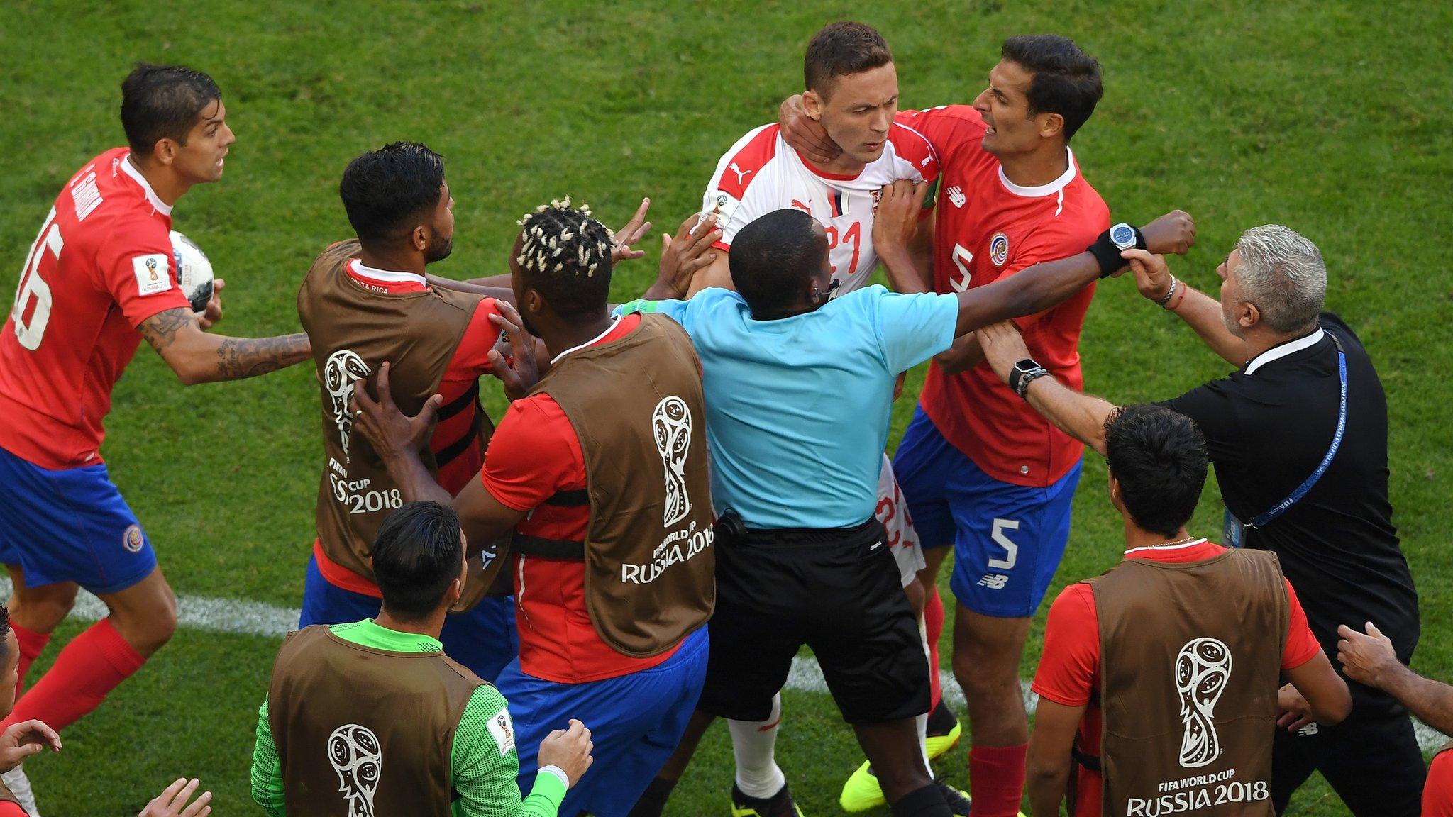 Players clash during Serbia v Costa Rica