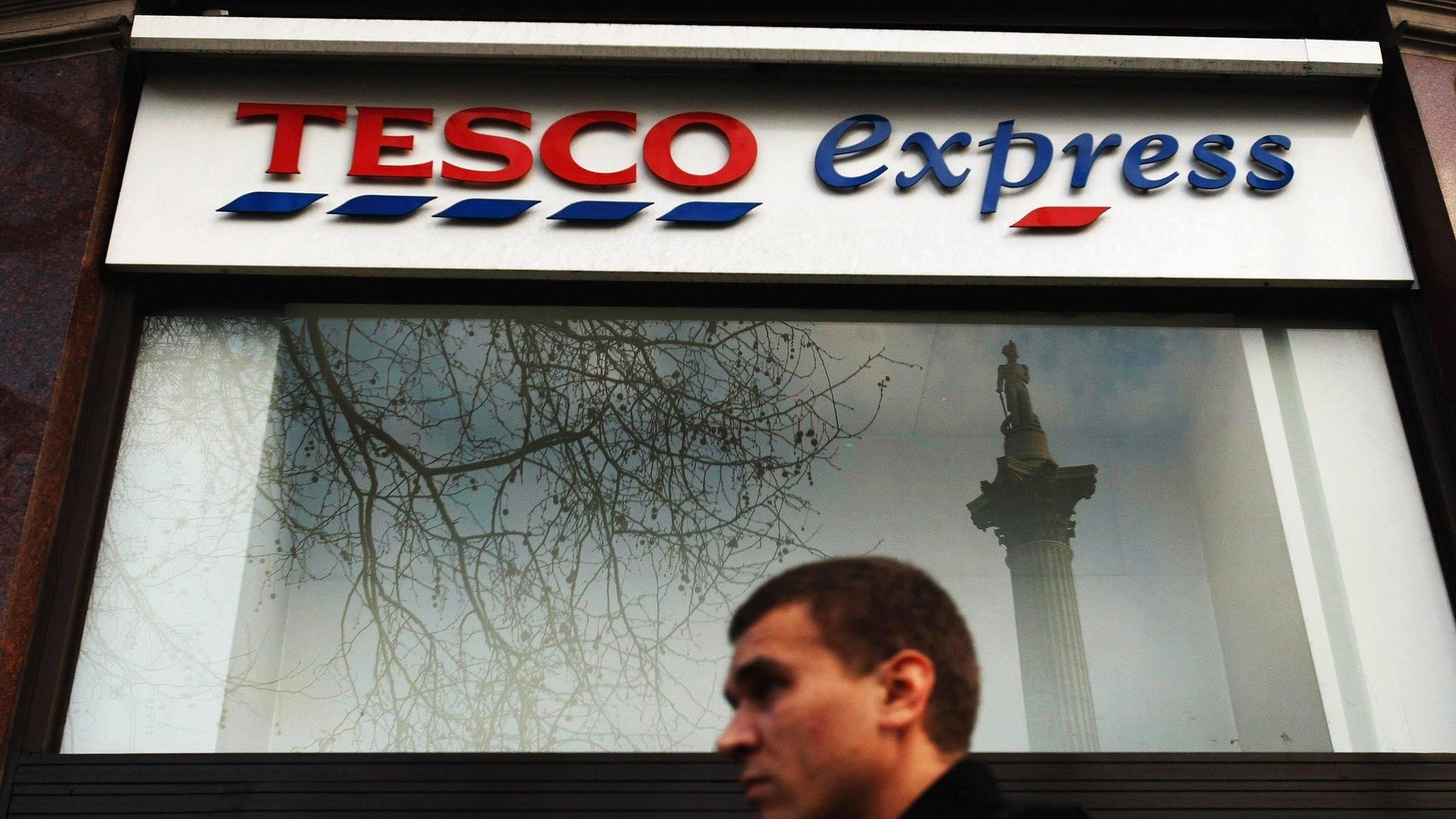 Man walks past Tesco Express