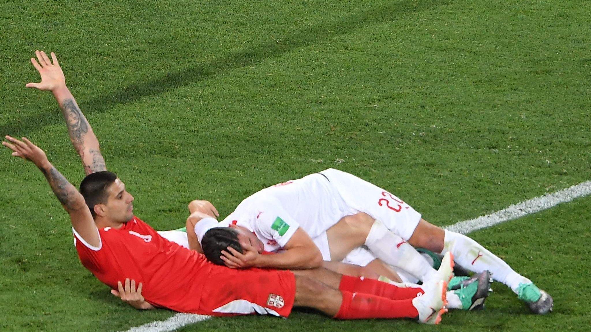 Serbia's Aleksandar Mitrovic reacts after a tackle against Switzerland