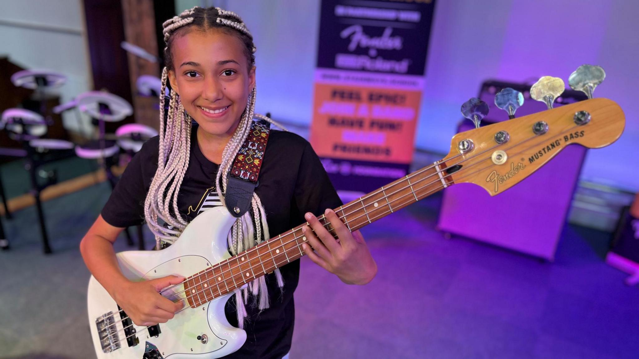 Nandi Bushell with a bass guitar