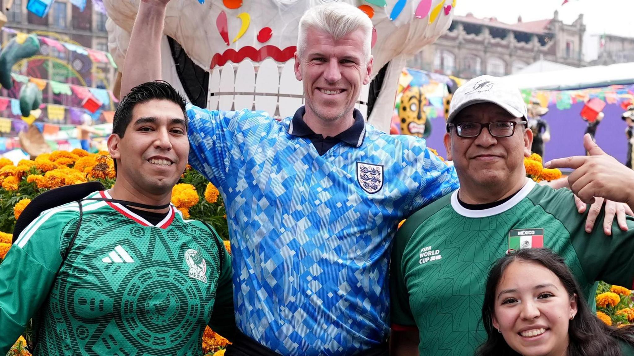 An England fan poses for a picture with Mexico fans in Plaza de la Constitucion, Mexico City. England face Mexico in their FIFA World Cup 2026 round of 16 match on Monday.
