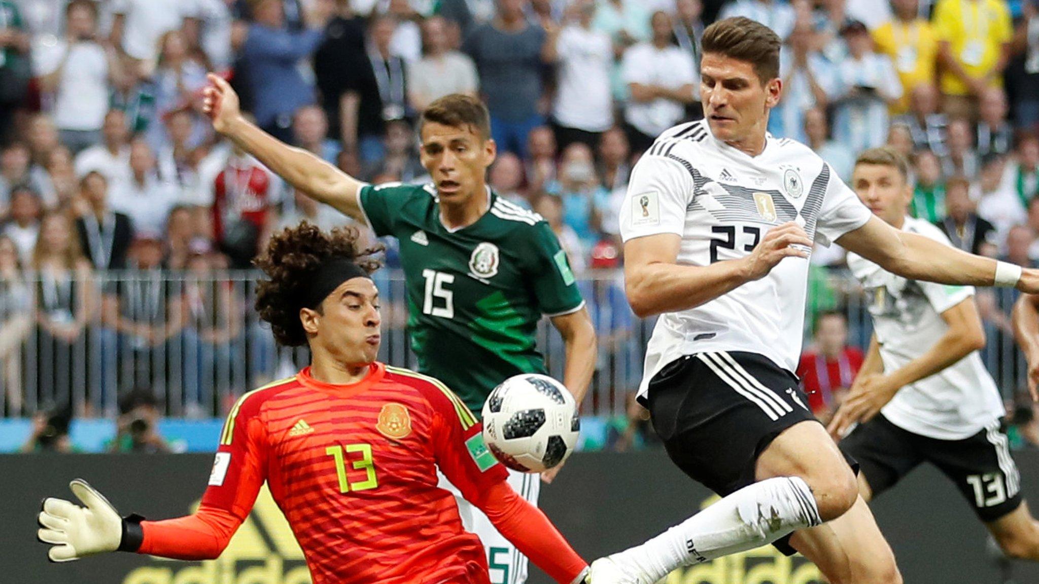 Germany's Mario Gomez shoots at goal as Mexico's Guillermo Ochoa challenges