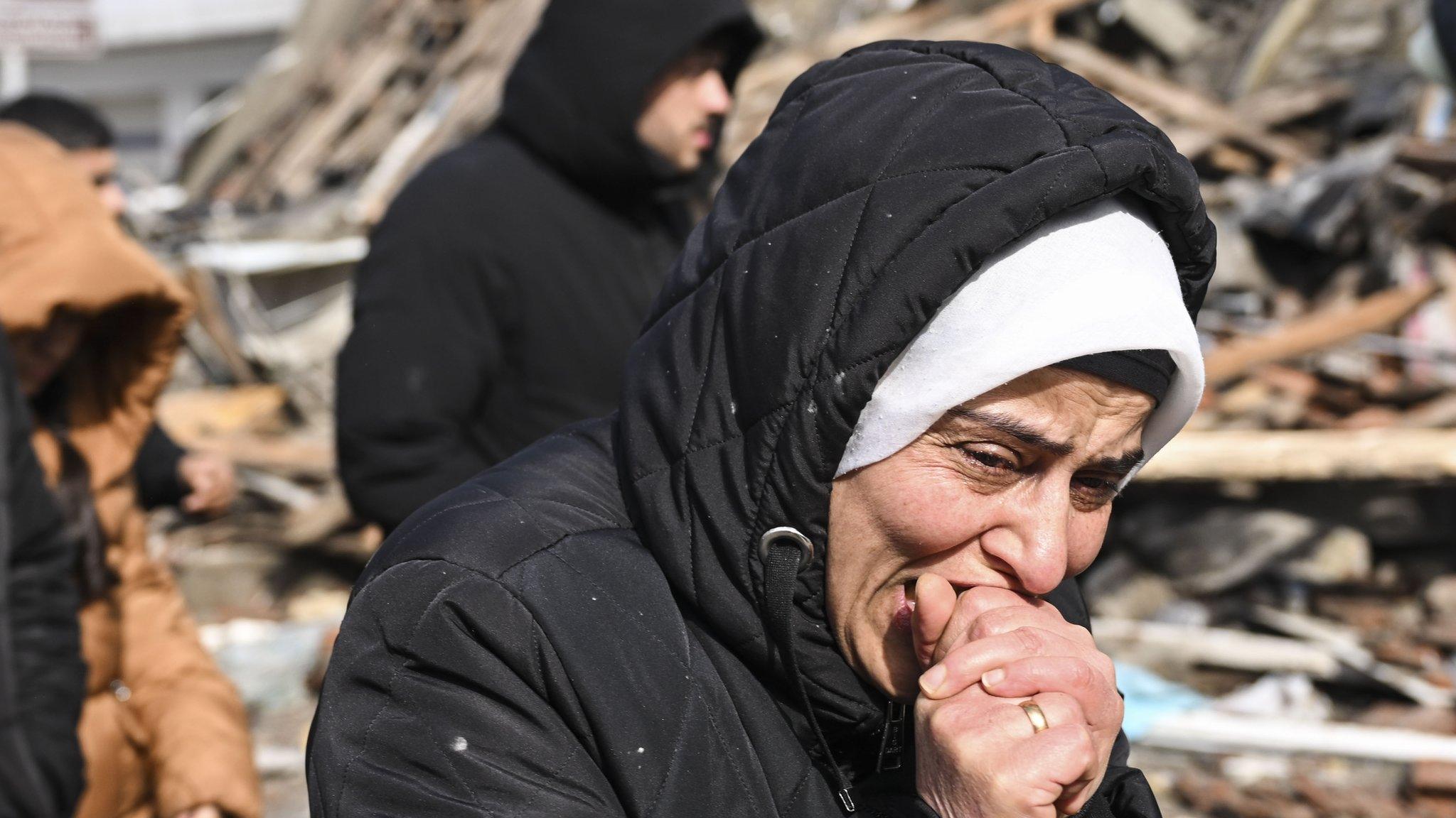 A woman grieves near a collapsed building in the Turkish city of Kahramanmaras (7 February 2023)