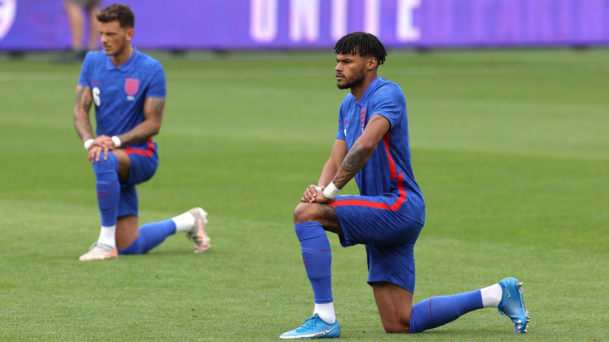 England defender Tyrone Mings takes a knee before the friendly with Romania