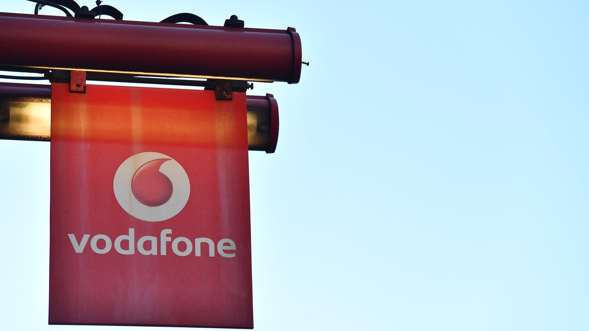 The logo of British mobile phone giant Vodafone welcomes visitors at their retail shop in central London on January 30, 2018.