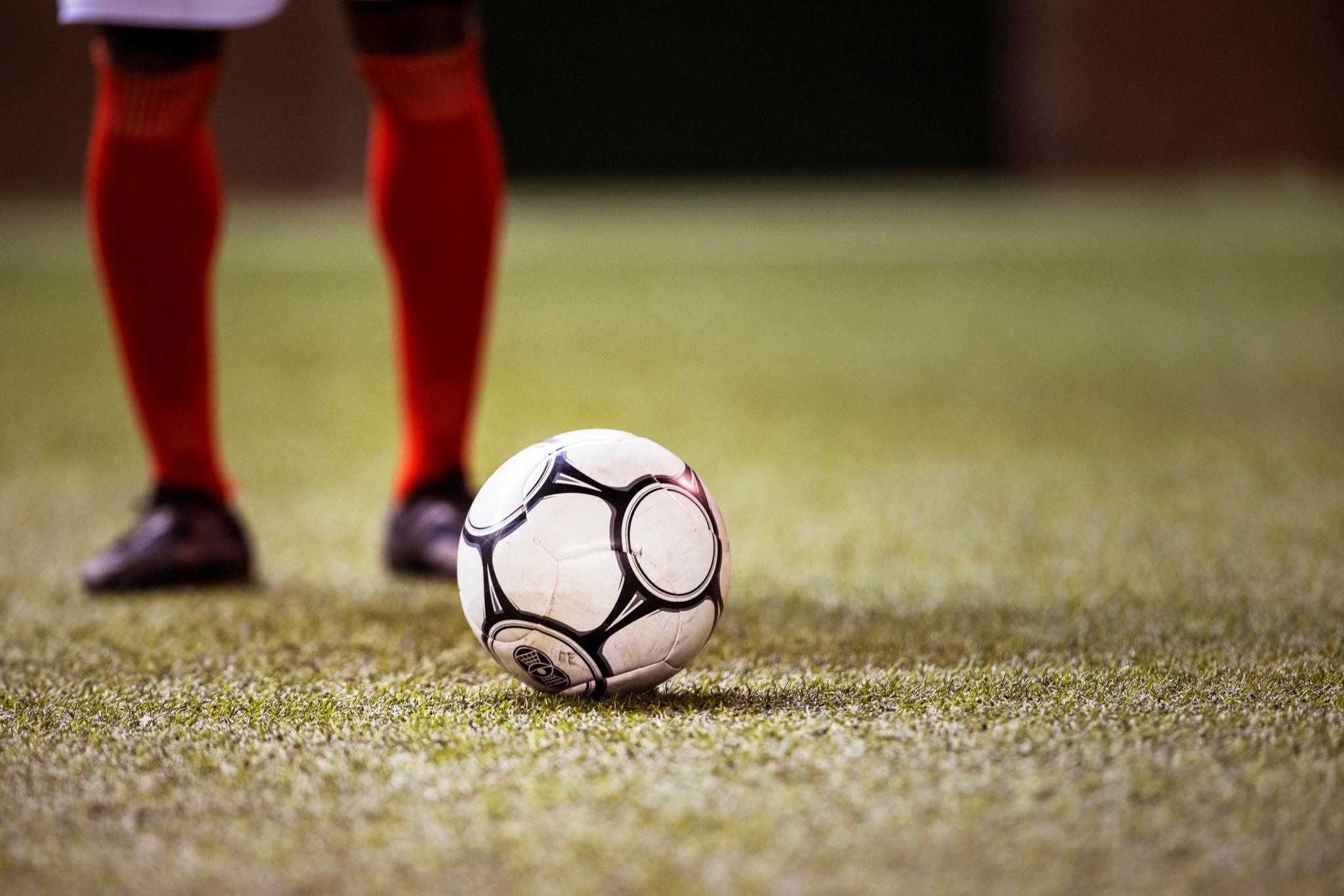 Football with a player stood behind