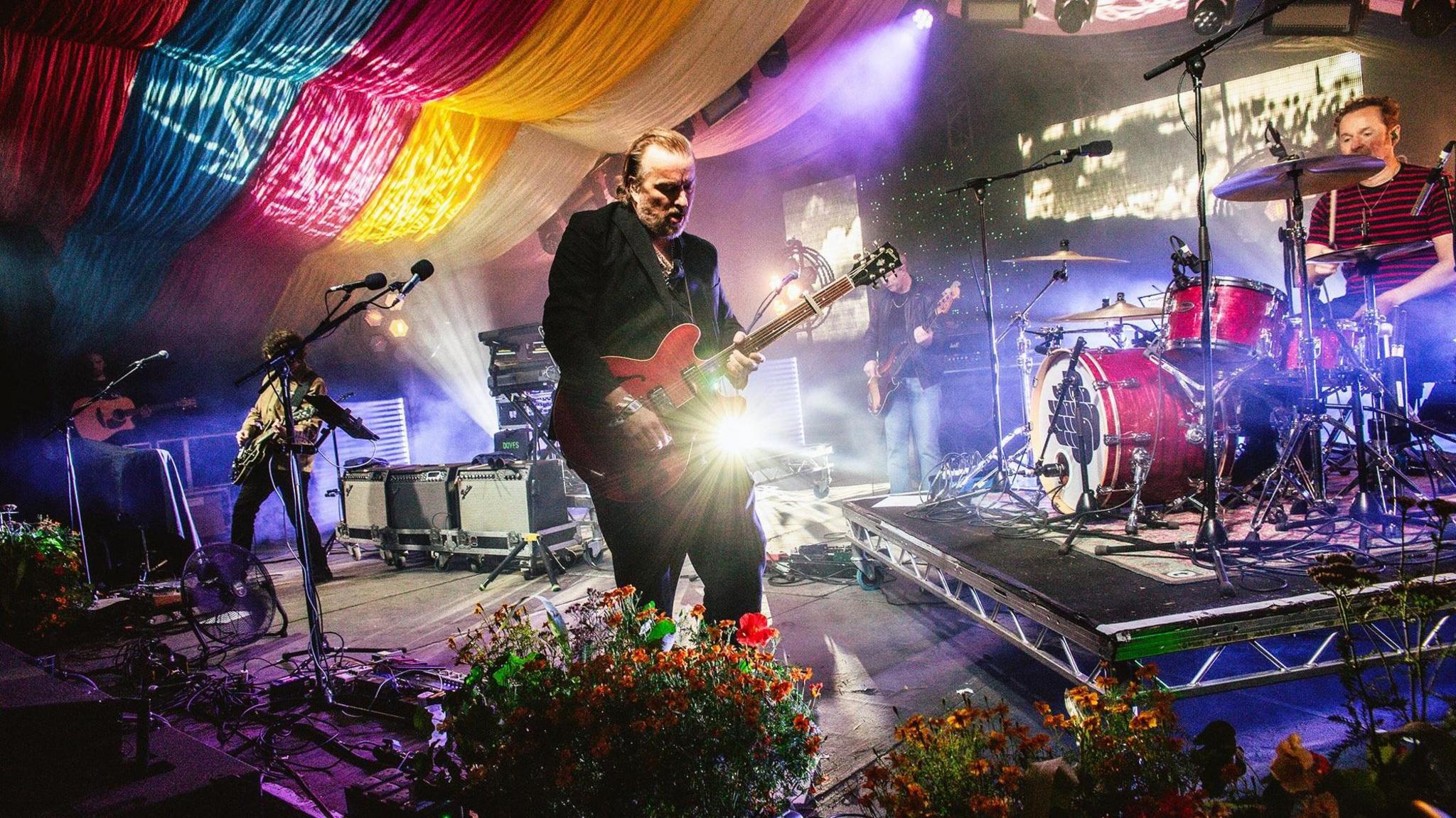 Doves on stage with guitarist Jez Williams in the foreground and brother Andy on drums in the background.