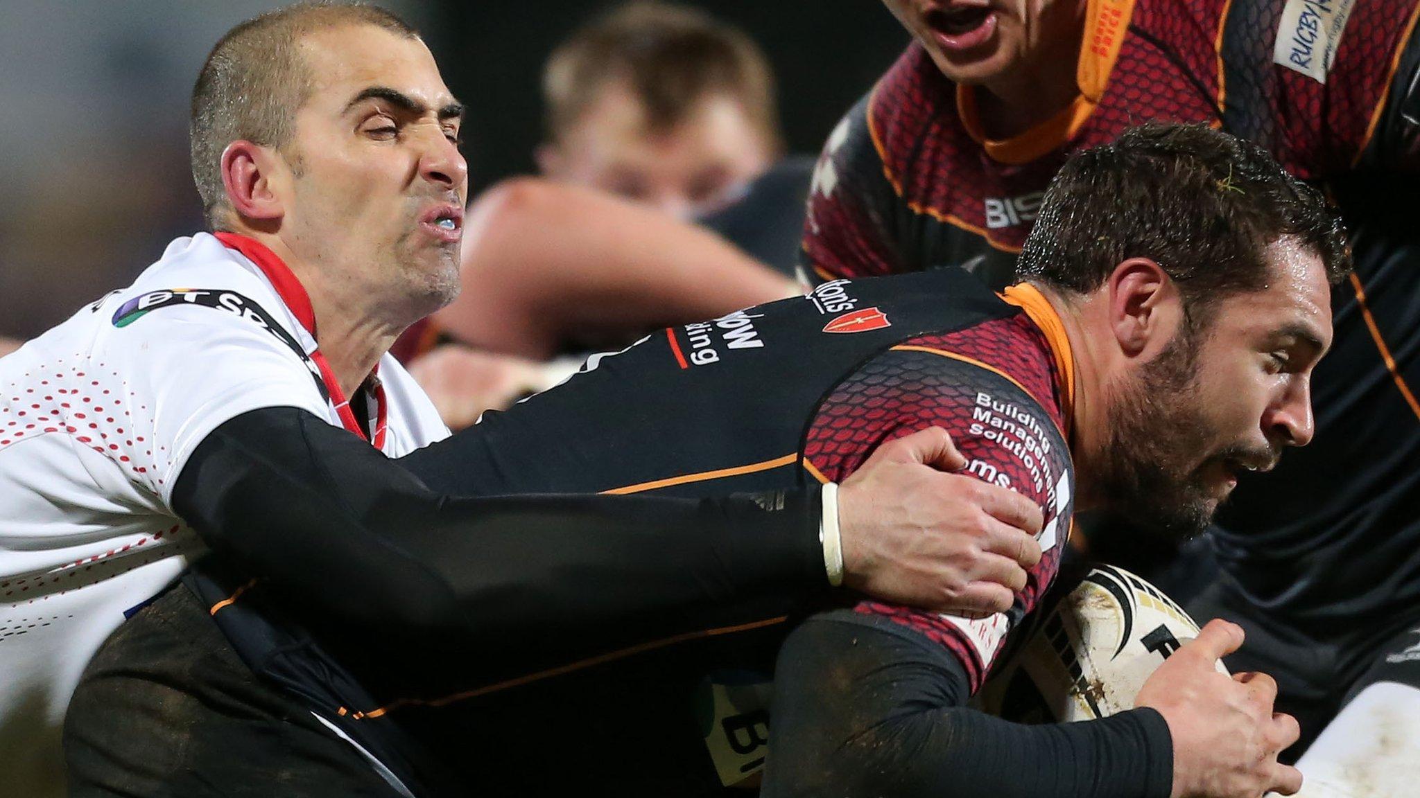 Ulster's Ruan Pienaar tackles Dragons scrum-half Charlie Davies at Kingspan Stadium