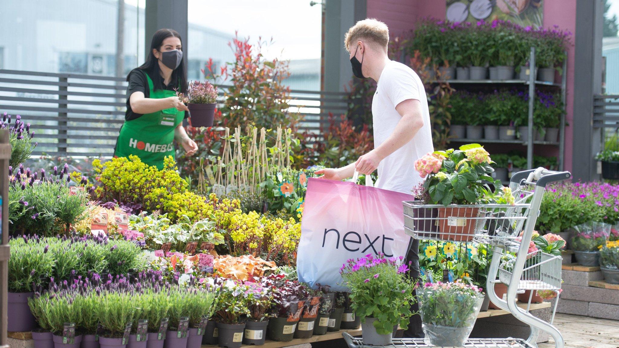 Shopper outside Next buying Homebase plants