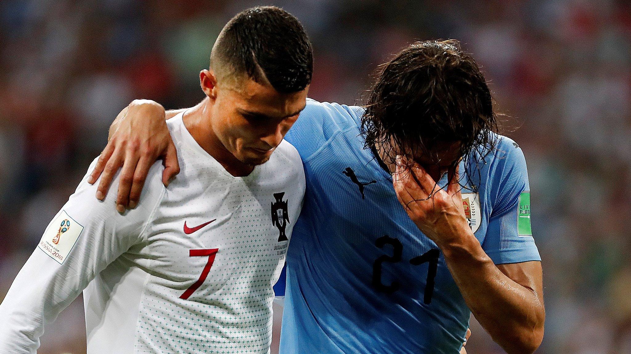 Edinson Cavani is helped from the field by Cristiano Ronaldo