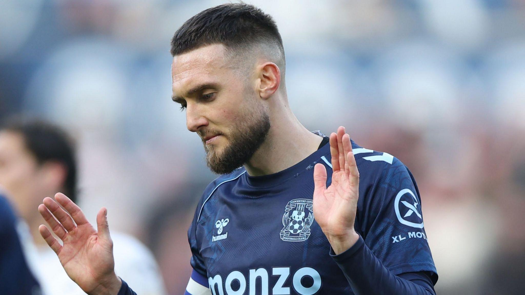 Matt Grimes holds his hands in the air after scoring 