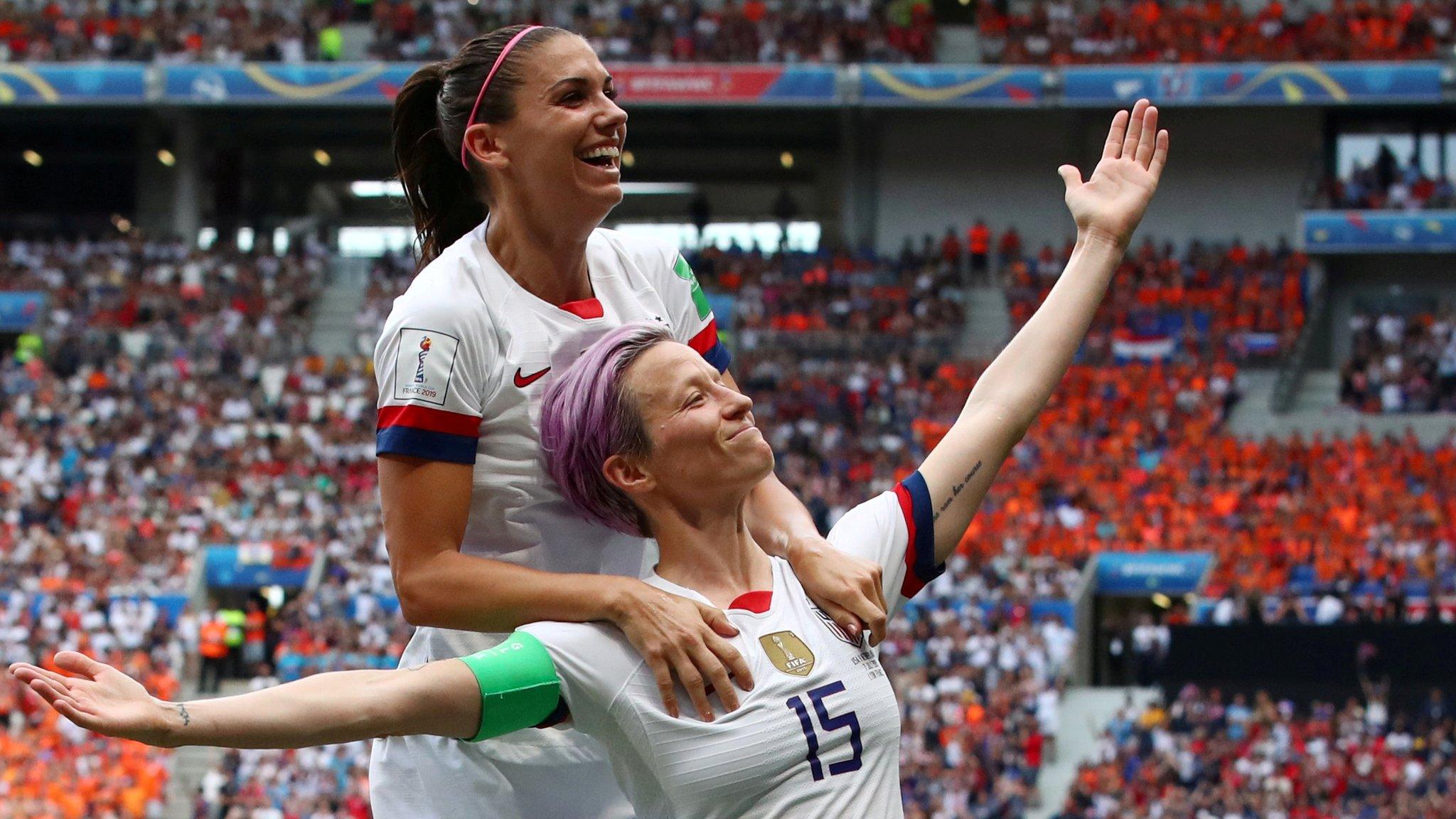 Megan Rapinoe celebrates with Alex Morgan