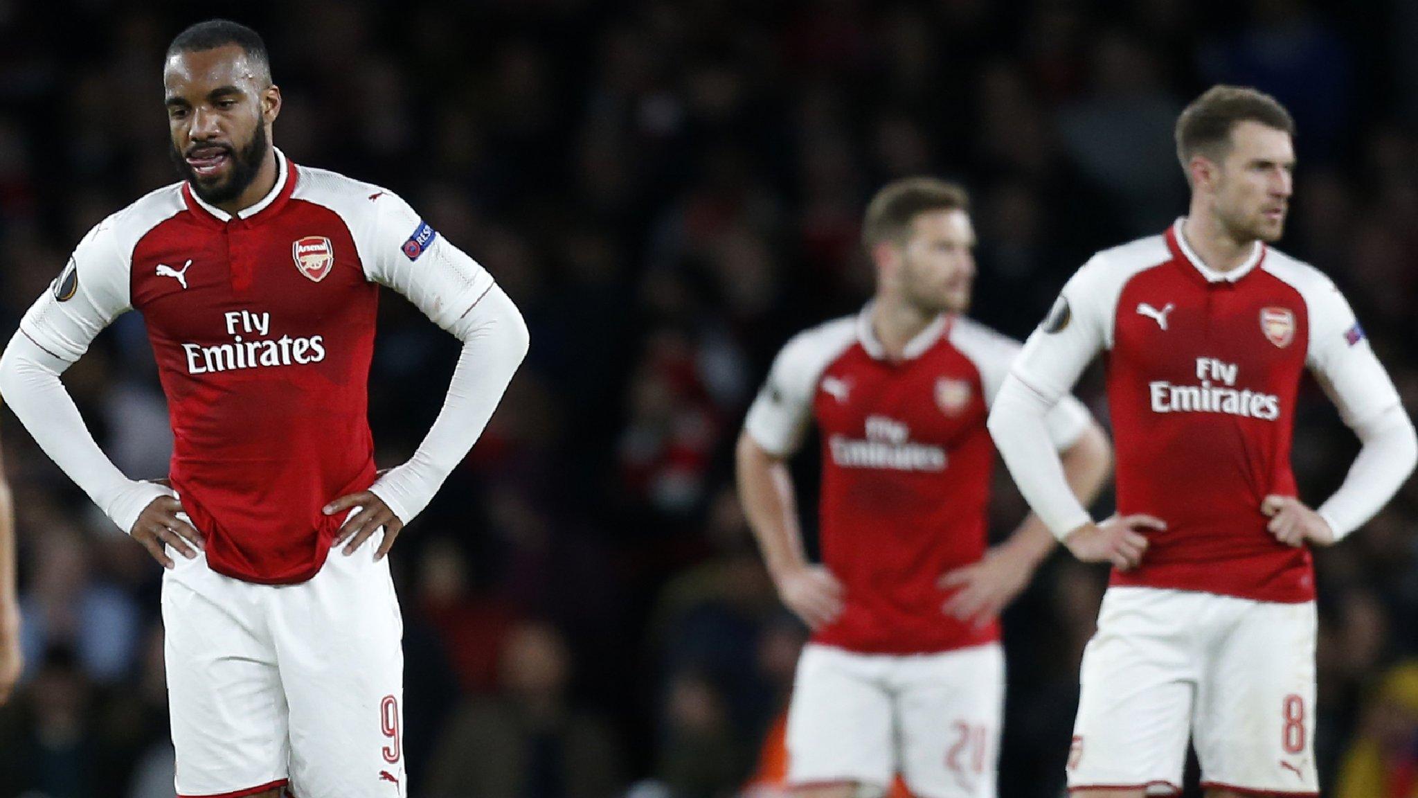 Arsenal players look on disappointed after Griezmann scores for Atletico