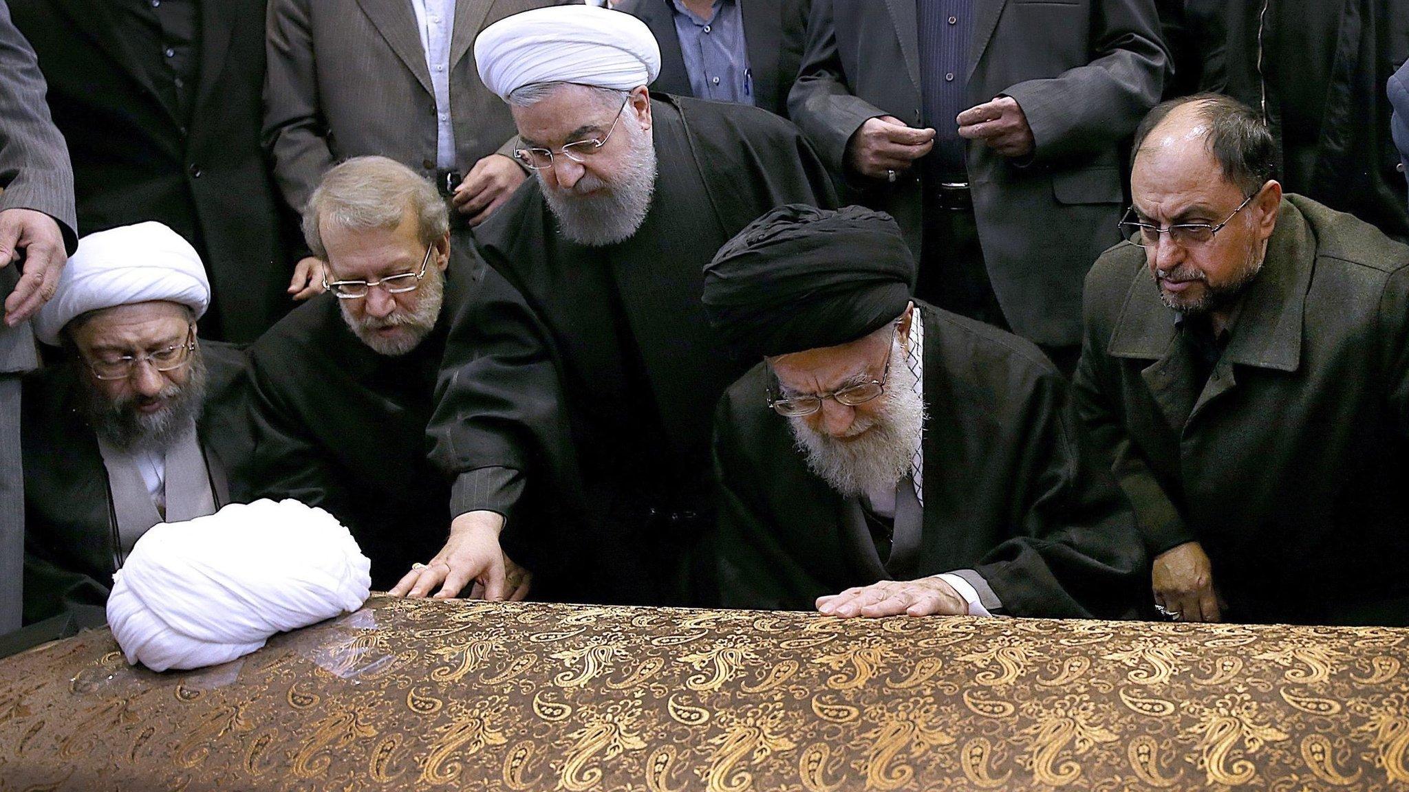 Iranian Supreme Leader Ayatollah Ali Khamenei (2-R) and Iranian President Hassan Rouhani (C) touch the coffin of Akbar Hashemi Rafsanjani at his funeral ceremony in Tehran, Iran (10 January 2017)