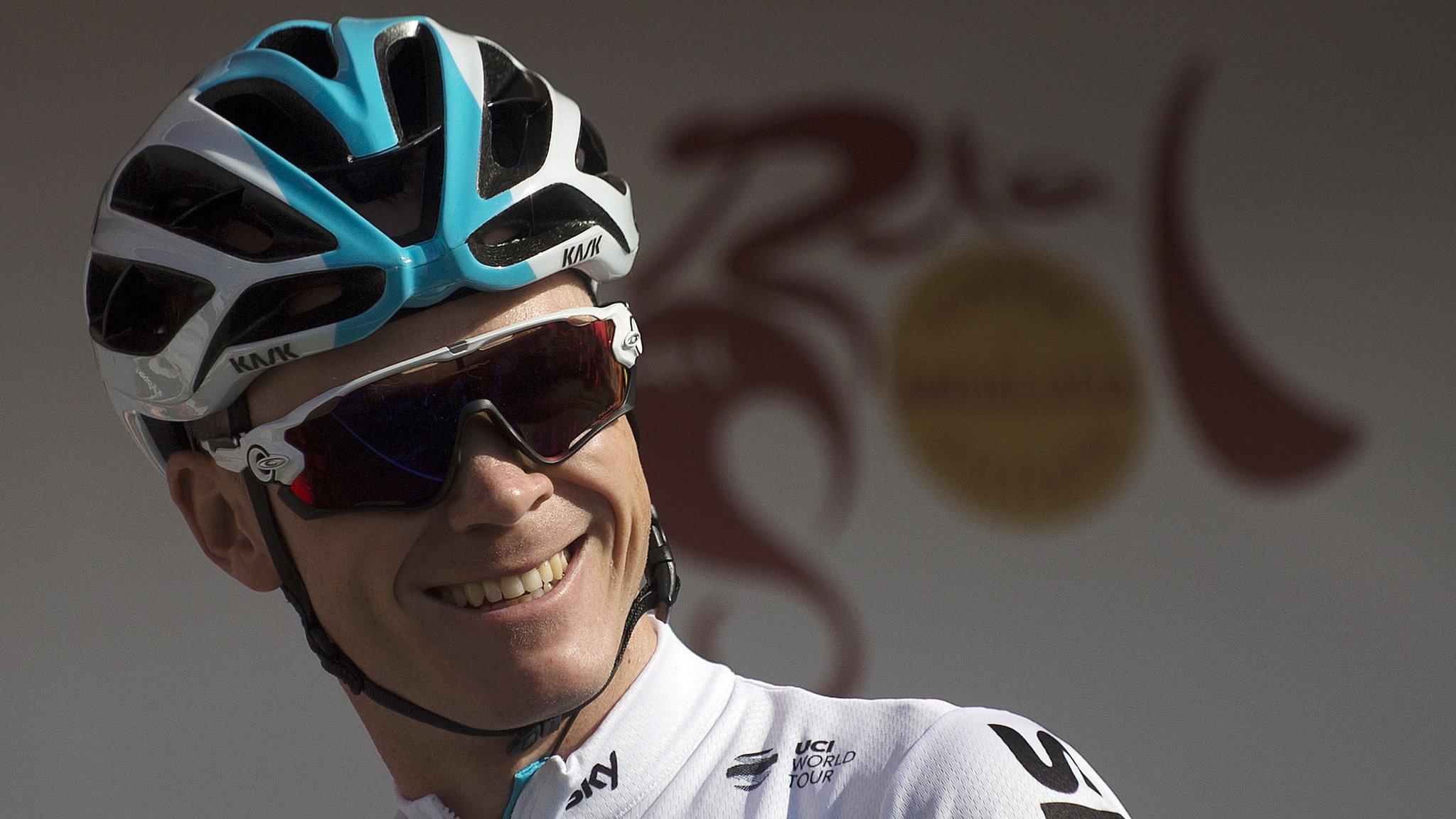 Team Sky cyclist Chris Froome smiles wearing a helmet and sunglasses