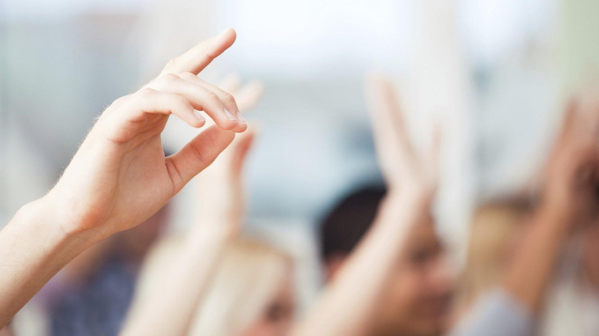 Hands up in a classroom