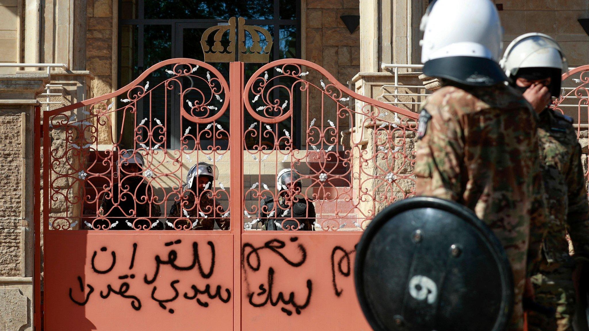 Iraqi security forces stand outside an entrance to the Swedish embassy in Baghdad, after protesters stormed the compound (29 June 2023)