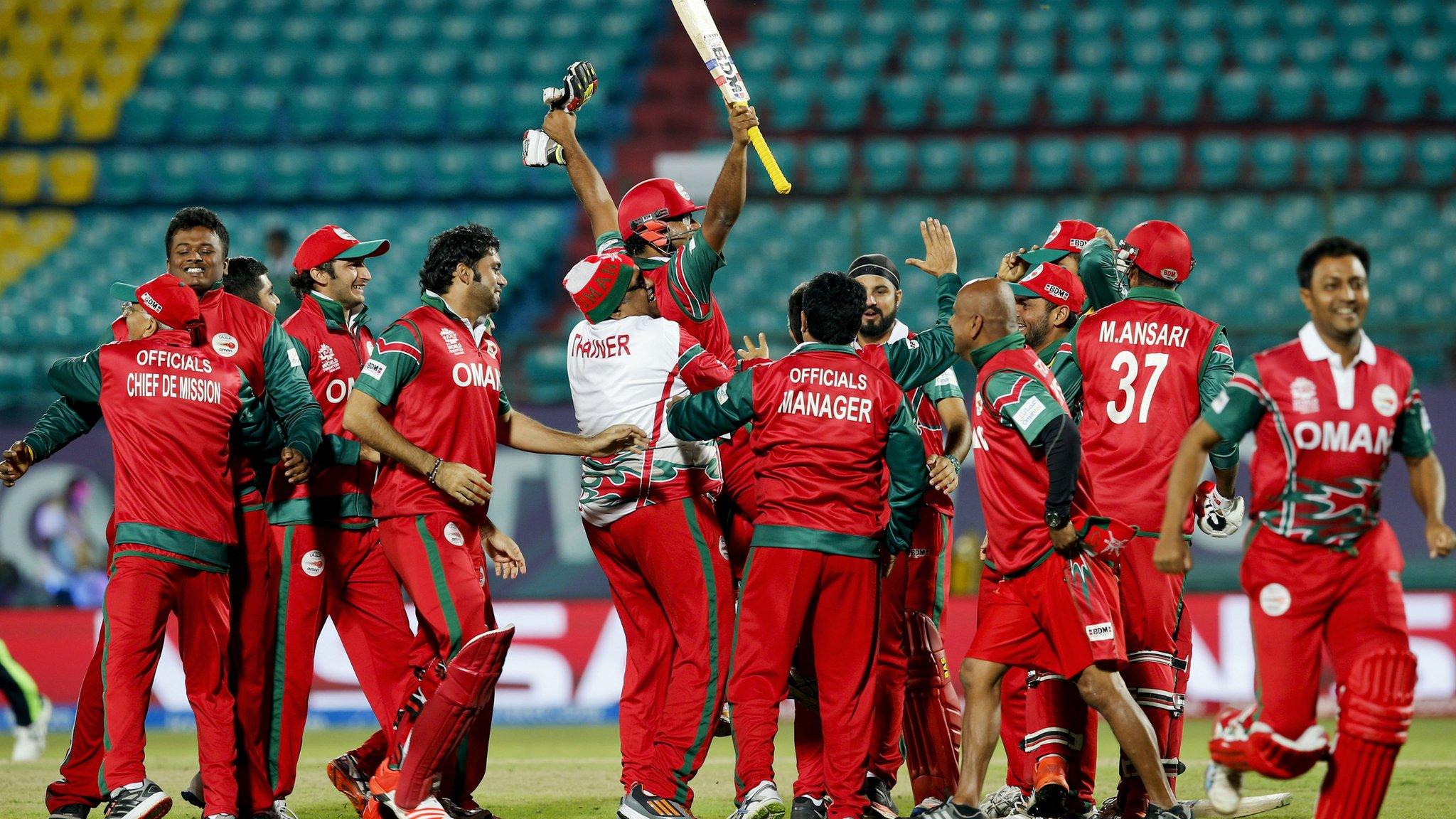 Oman's players celebrate