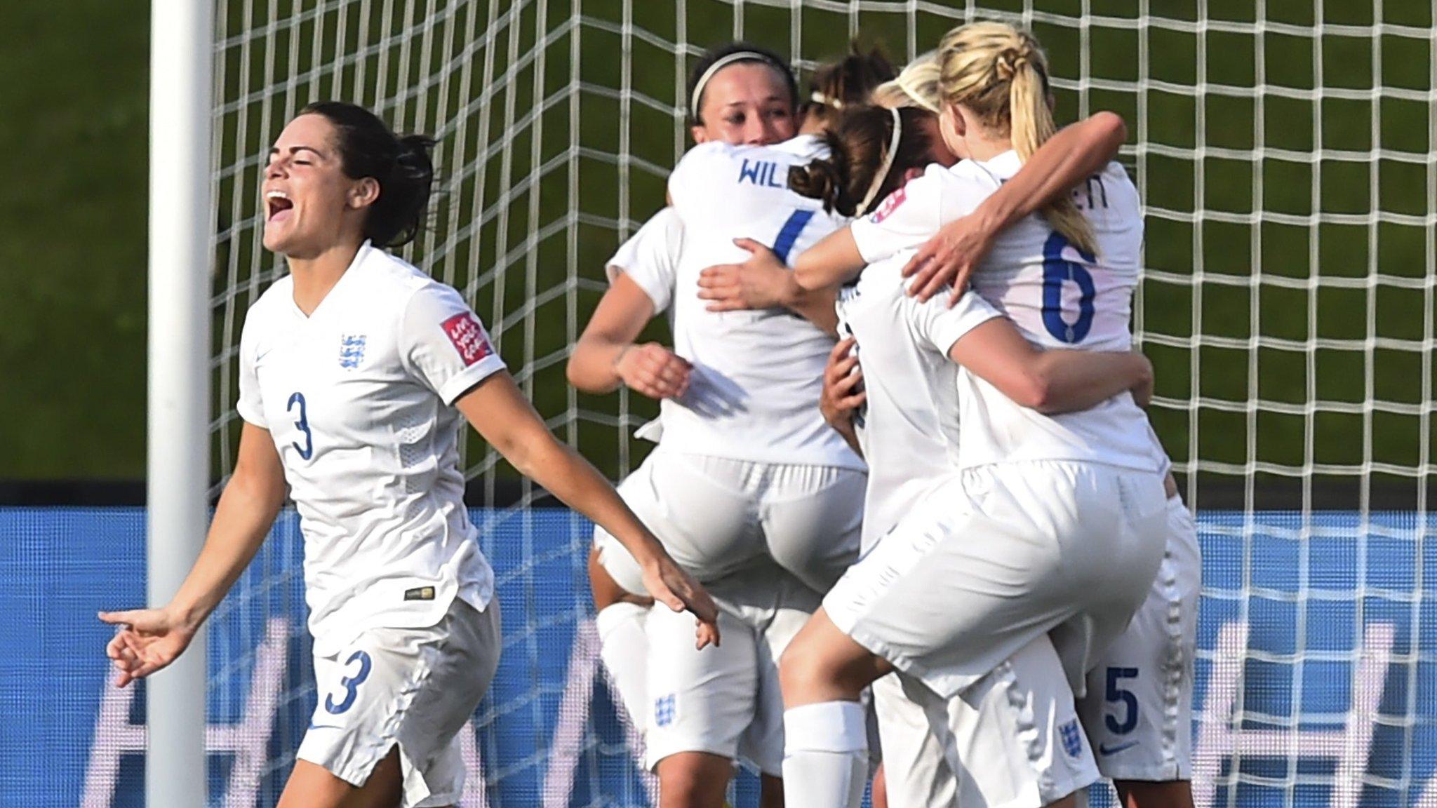 England women's football team celebrating a win.