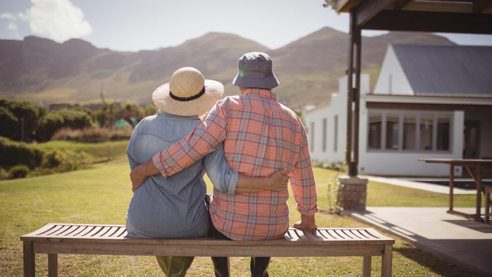 An older couple sitting on a bench