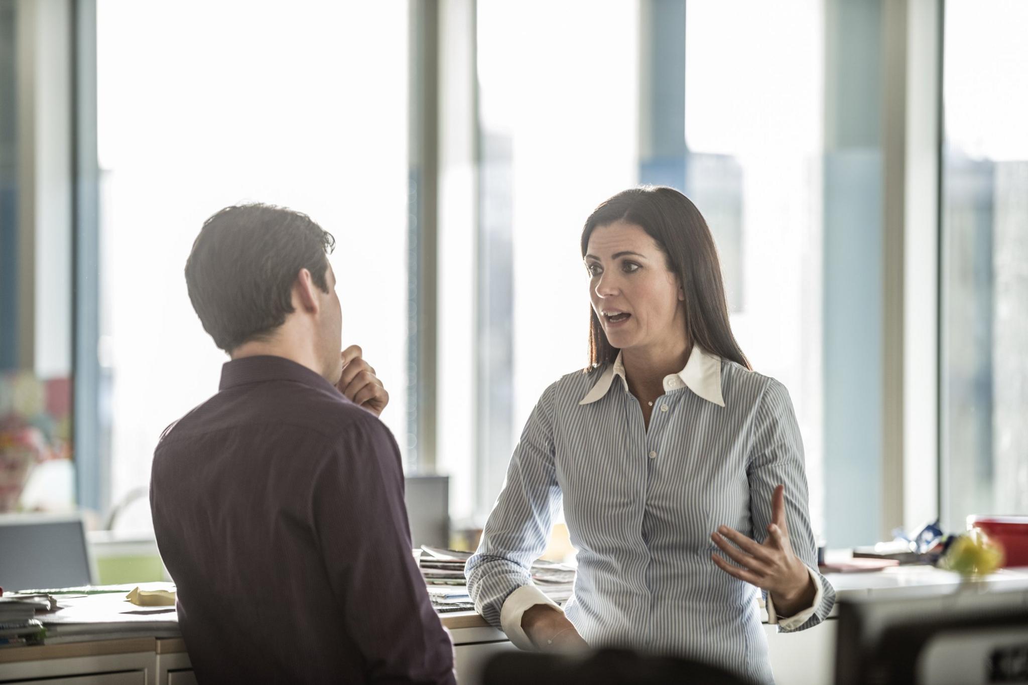 Man and woman talking in an office