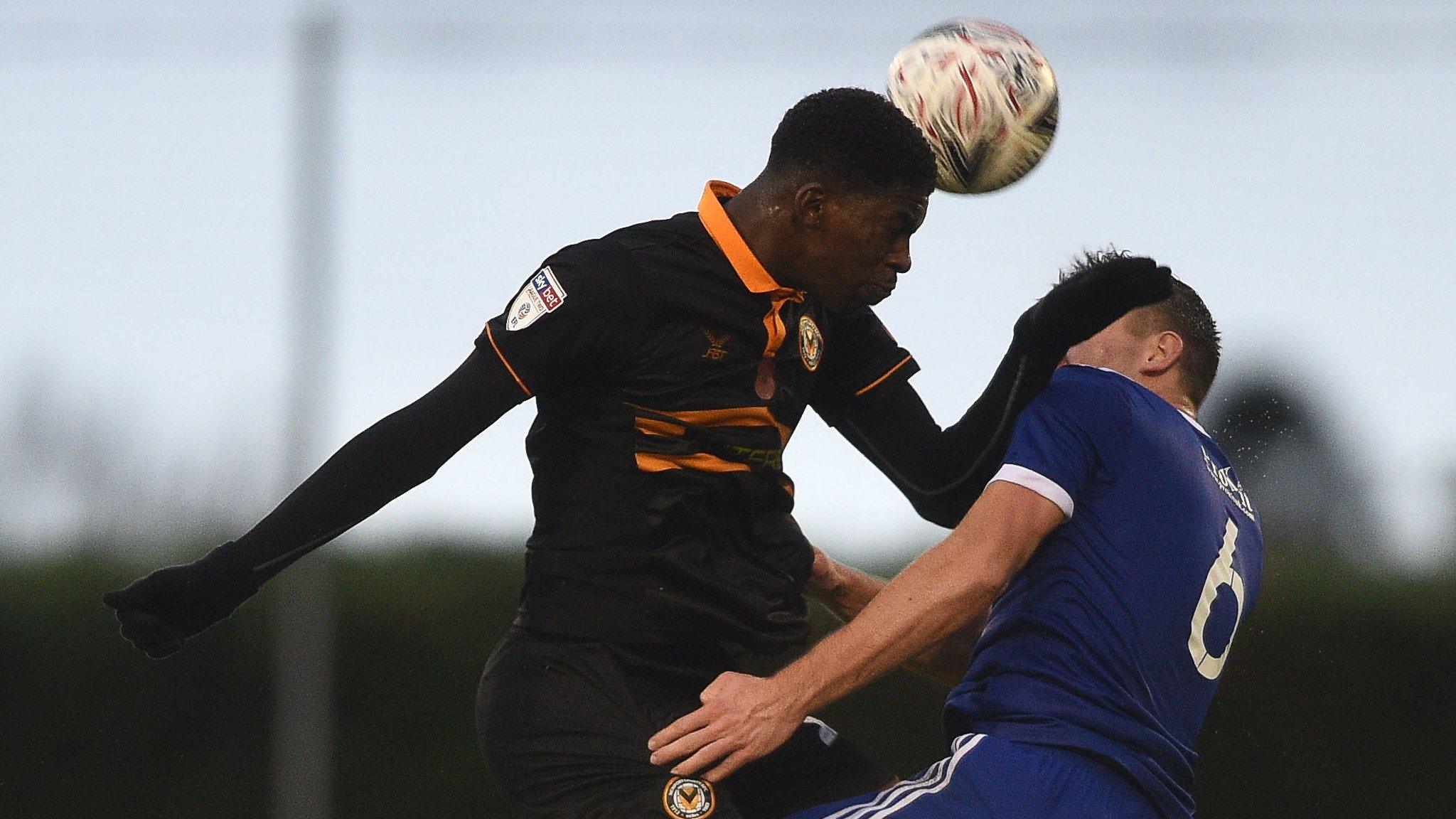 Tyreeq Bakinson of Newport County fouls Louis Birch of Metropolitan Police