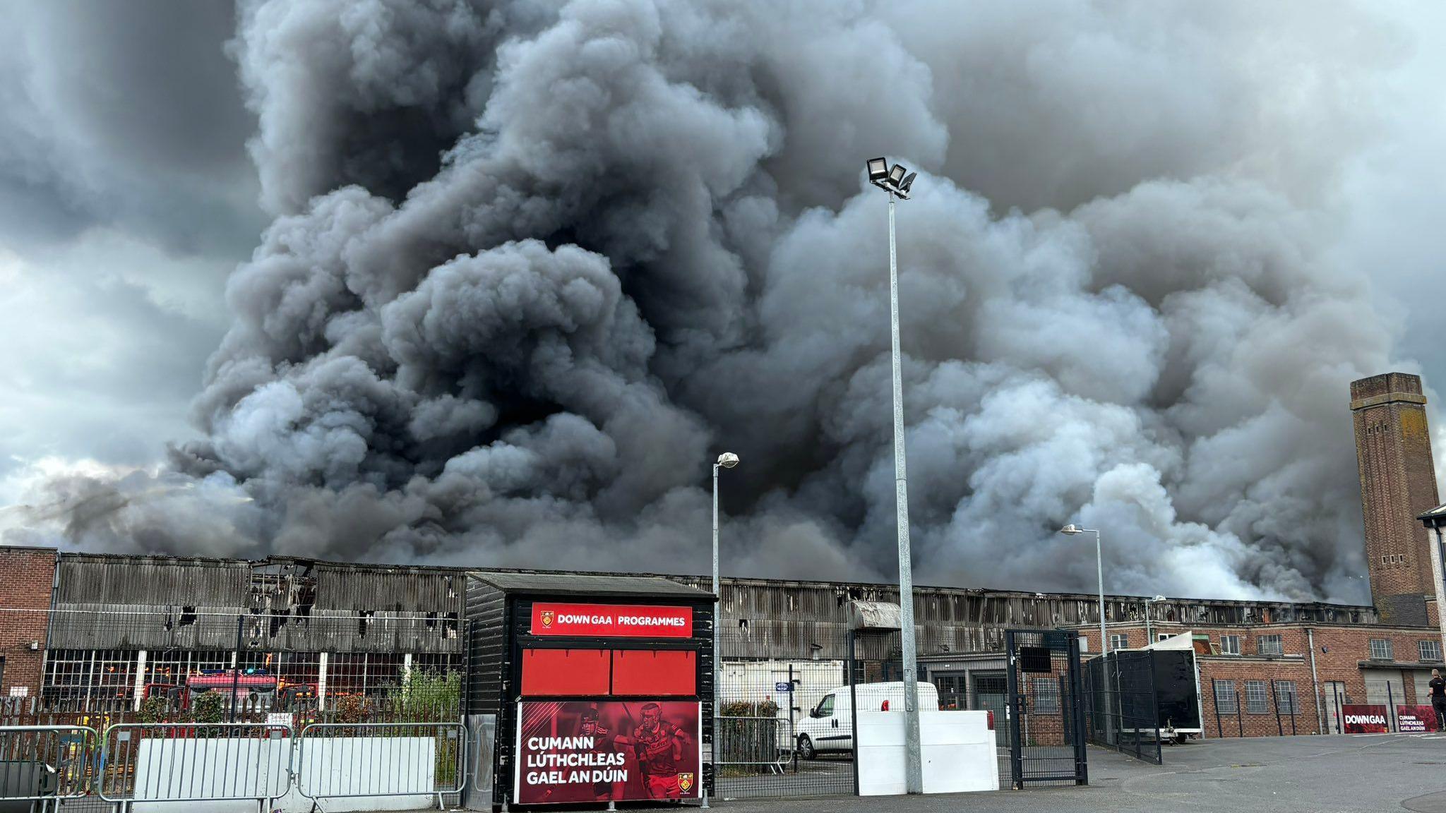 The fire is close to Páirc Esler GAA stadium and various business premises