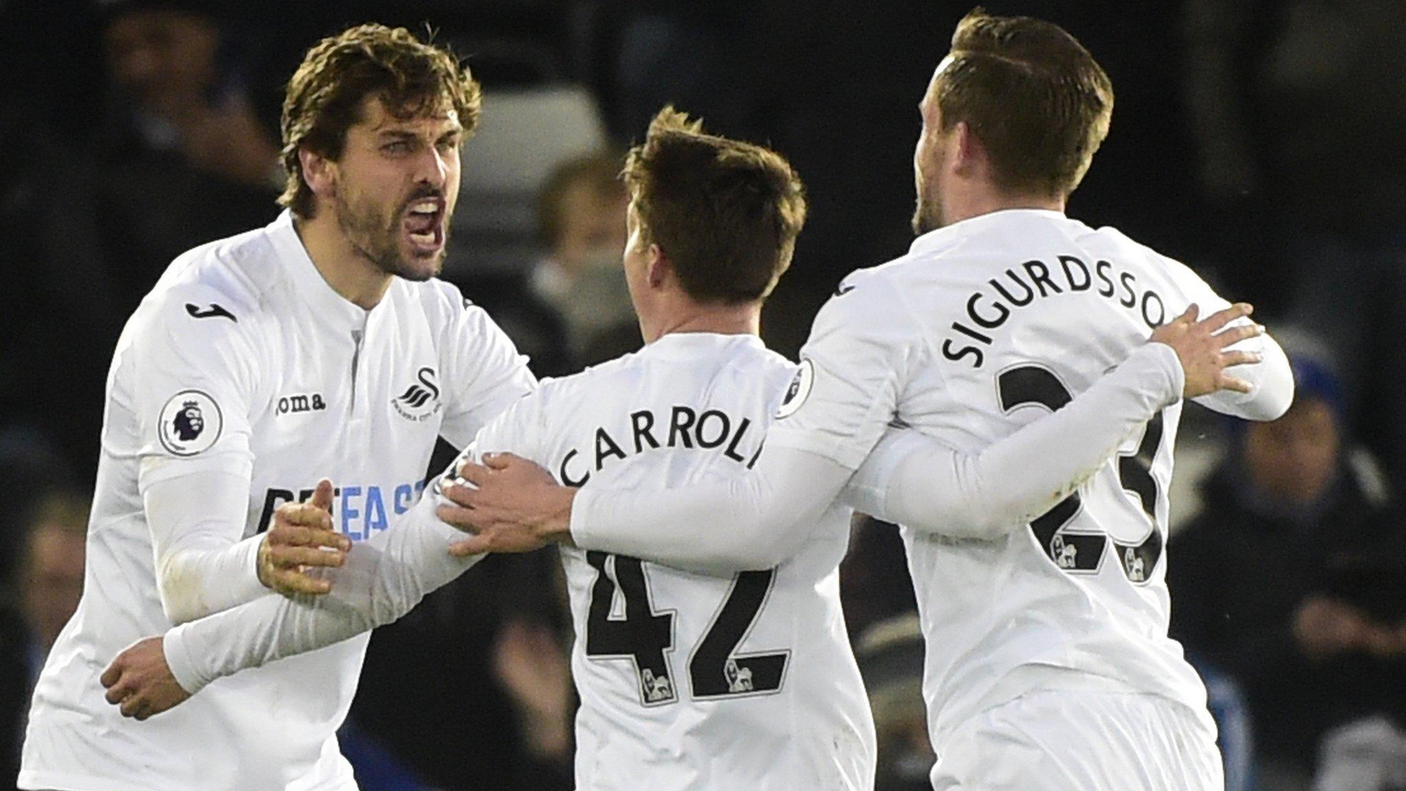 Swansea City's players celebrate scoring against Leicester City