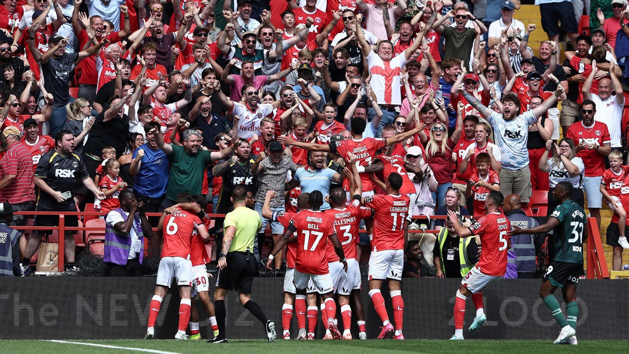 Charlton Athletic celebrating with fans during their opening Championship game against Watford
