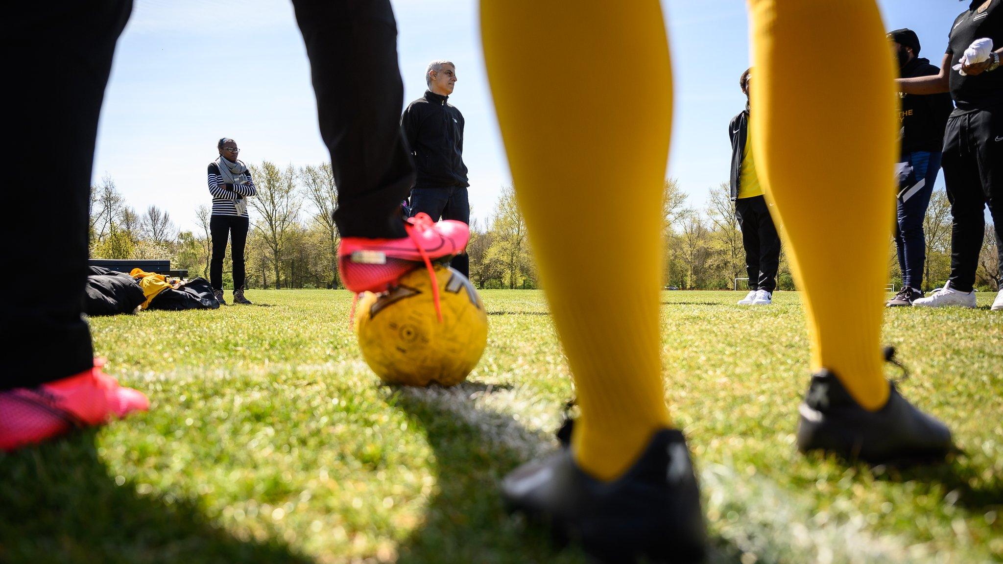 Footballers prepare to train at a grassroots sport event